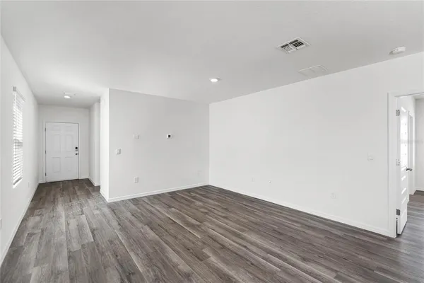 an empty room with wooden floor