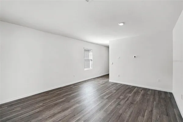 a view of an empty room and wooden floor