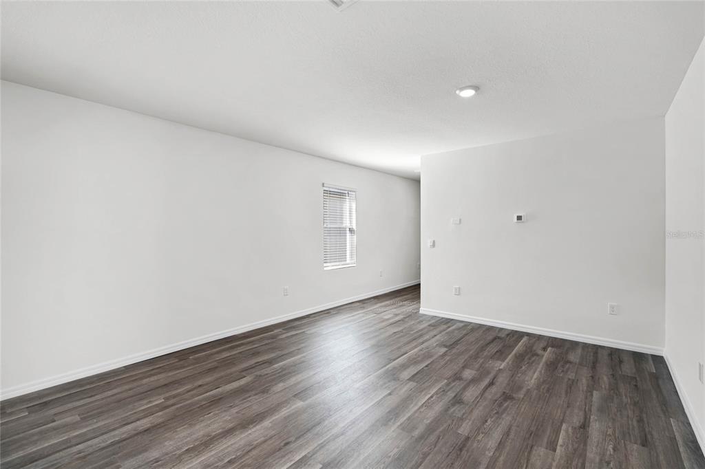 1726 Hummingbird Road Winter Haven, FL 33884 - Photo 5 of 28 a view of an empty room and wooden floor