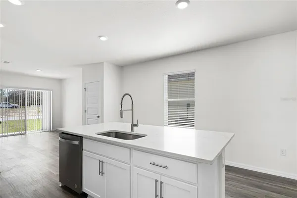 a kitchen with a sink and chandelier