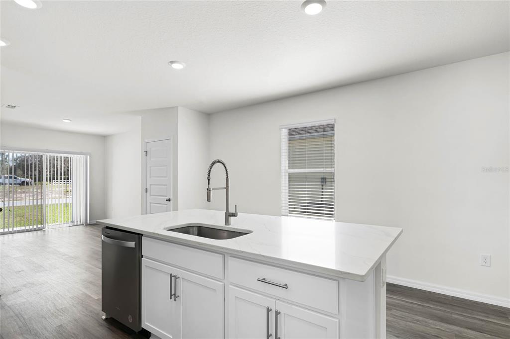 1726 Hummingbird Road Winter Haven, FL 33884 - Photo 8 of 28 a kitchen with a sink and chandelier