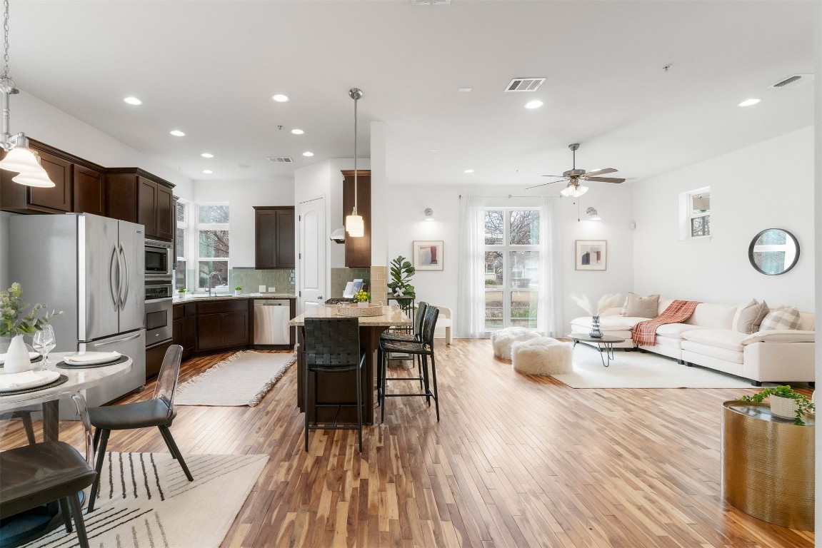 2008 Simond Avenue, Unit D Austin, TX 78723 - Photo 1 of 1 a living room with fireplace furniture wooden floor and a view of kitchen
