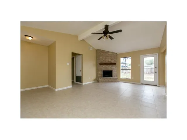 a view of empty room with a fireplace