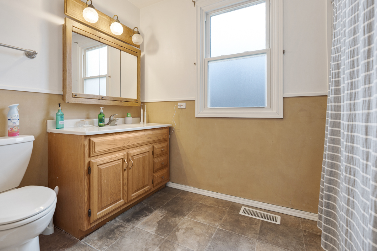 206 Yuma Lane Carol Stream, IL 60188 - Photo 12 of 26 a bathroom with a granite countertop toilet sink and mirror