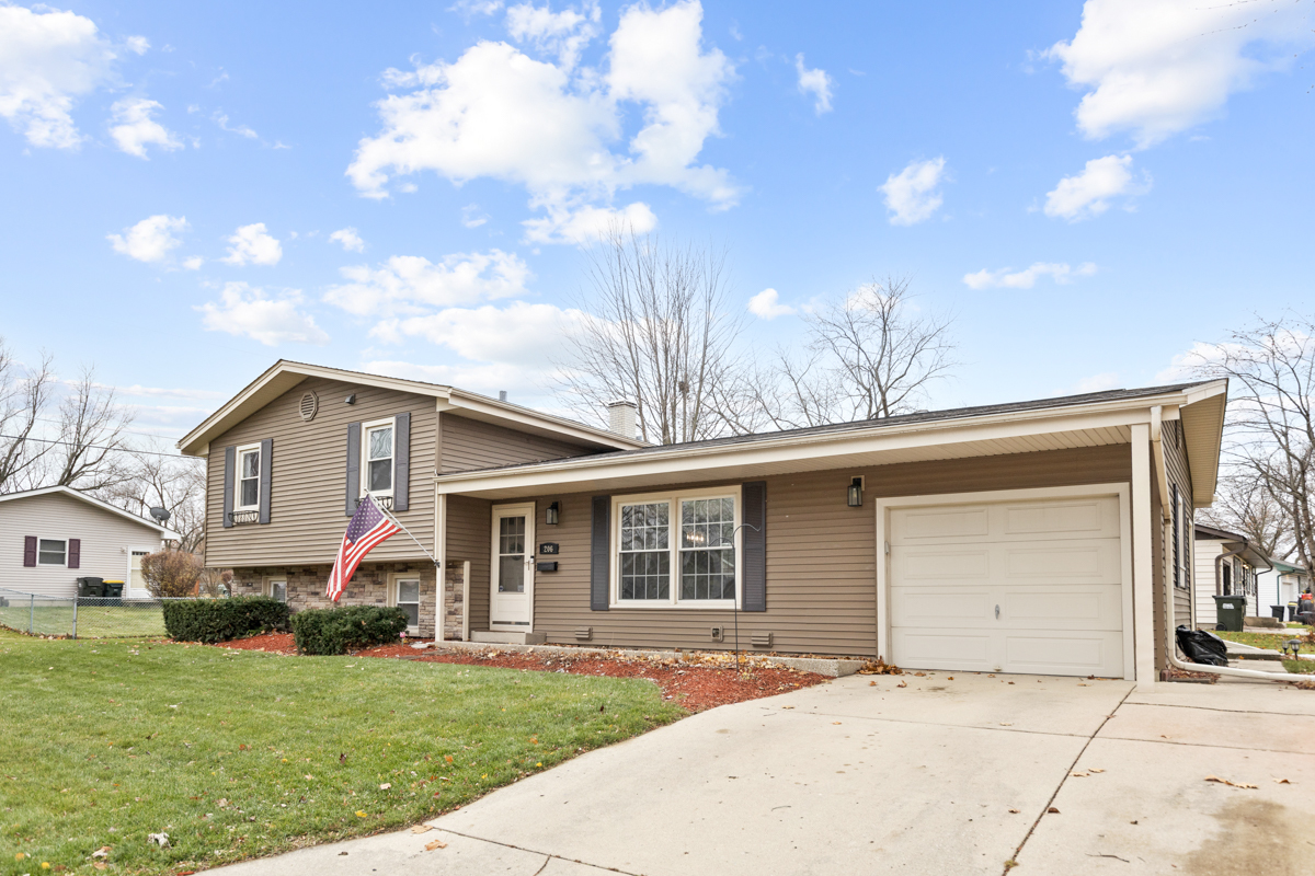 206 Yuma Lane Carol Stream, IL 60188 - Photo 2 of 26 a front view of a house with a garden and yard