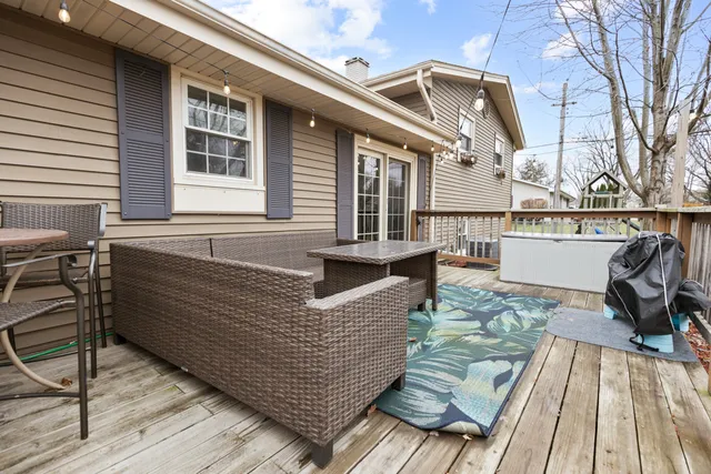 a view of a roof deck with couches and wooden floor