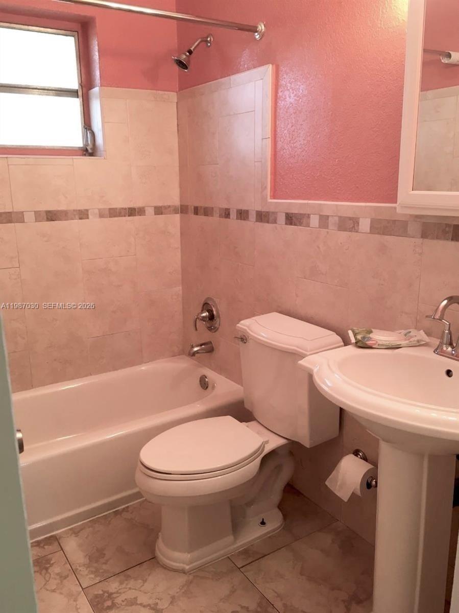 4250 Southwest 67th Avenue, Unit 32 Miami, FL 33155 - Photo 6 of 10 a bathroom with a sink a toilet and shower