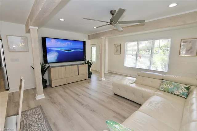 a spacious bedroom with a bed and a flat screen tv