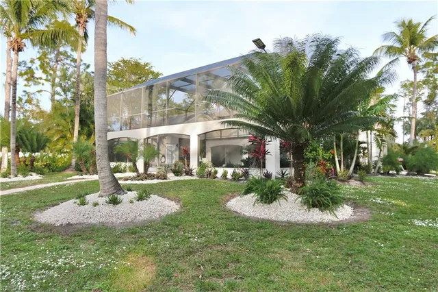 a view of a house with a yard and tree s