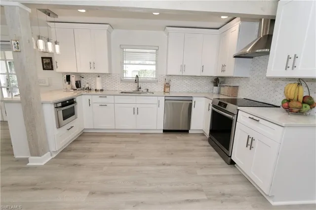 a living room with furniture kitchen view and a large window