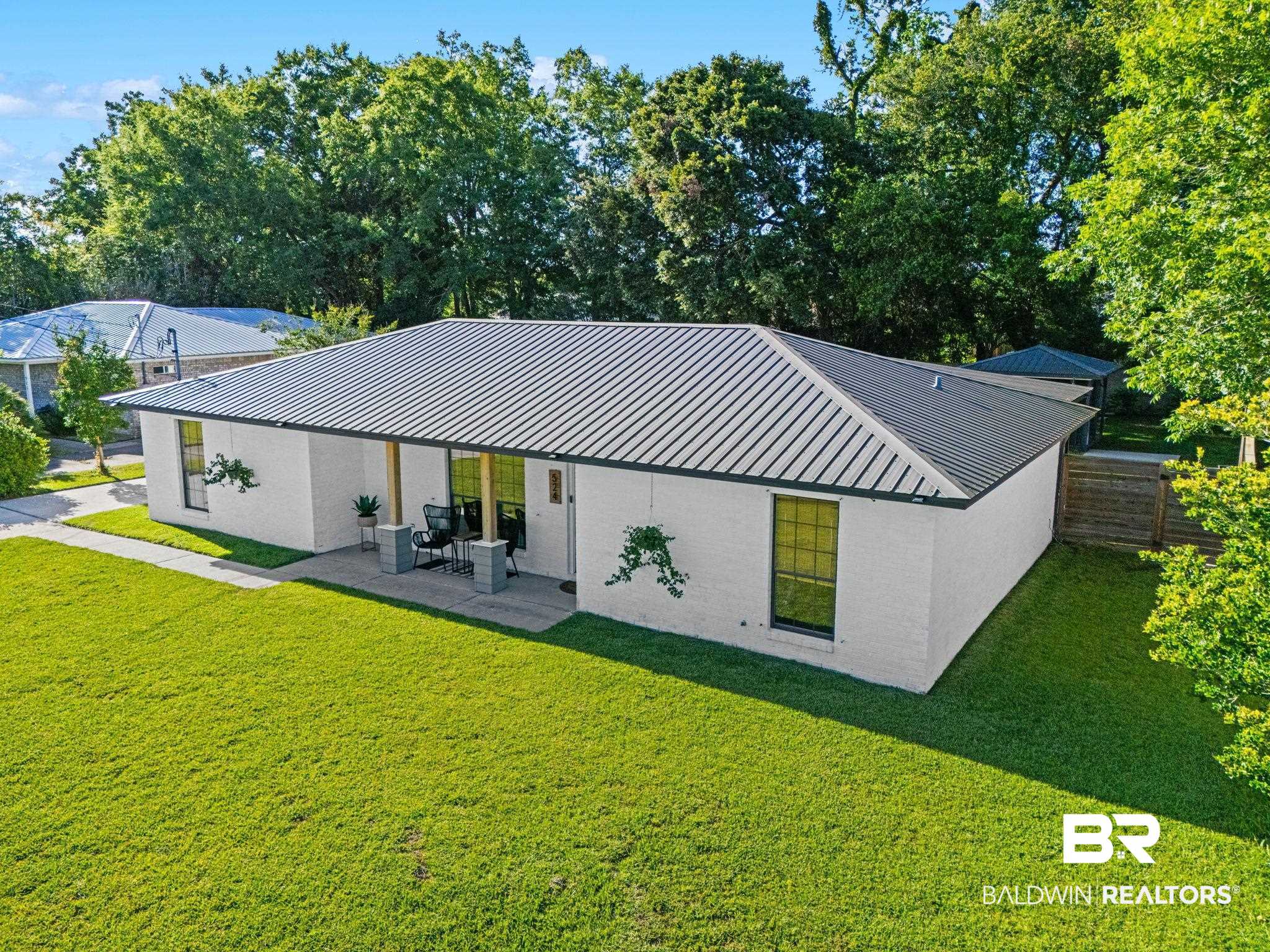 524 Ariel Avenue Foley, AL 36535 - Photo 36 of 37 White brick exterior with a dark metal roof