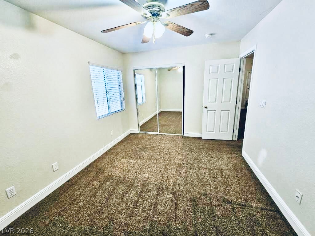 5953 Crumbling Ridge Street Henderson, NV 89011 - Photo 25 of 42 A comfortable bedroom with rich carpeting and mirrored closet doors provides a welcoming retreat.