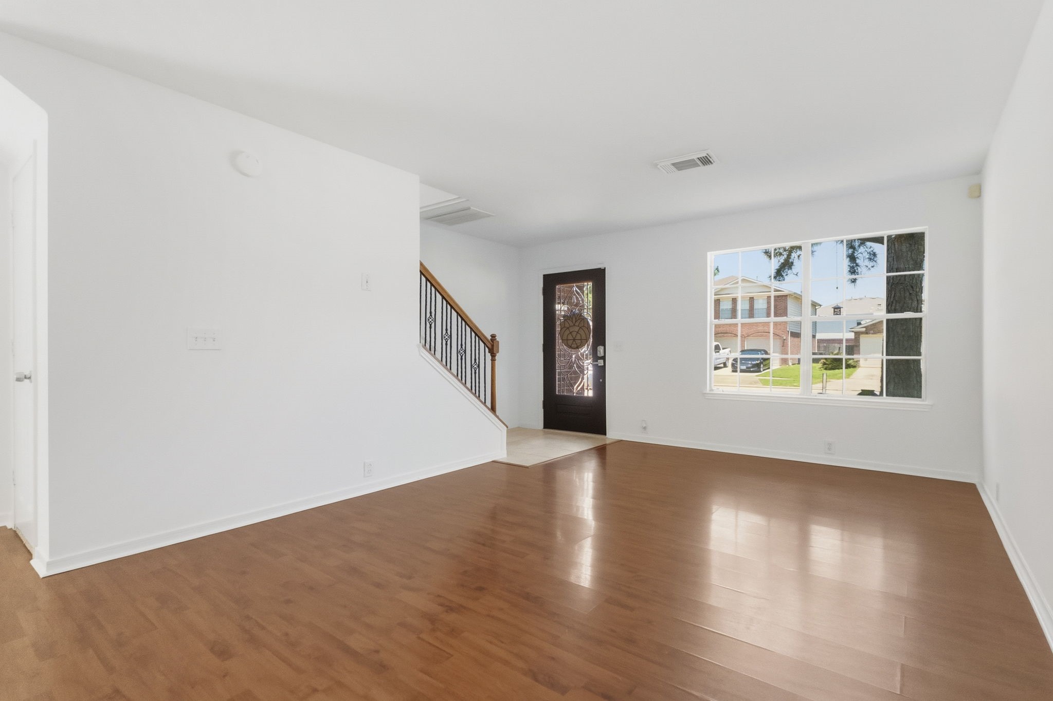 11907 Ezekiel Road Tomball, TX 77375 - Photo 6 of 39 a view of an empty room with window and wooden floor