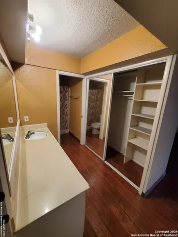 a white toilet sitting next to a shower curtain