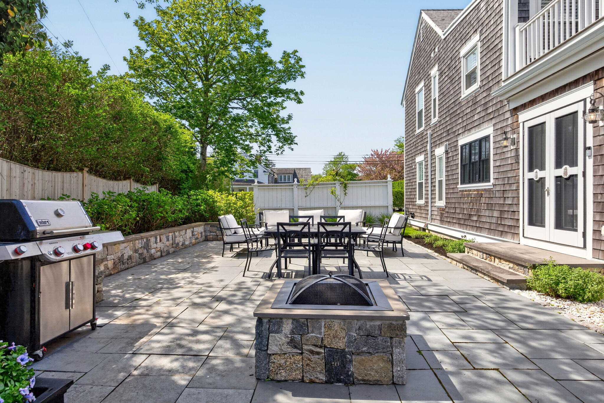 320 Old Harbor Road Chatham, MA 02633 - Photo 8 of 58 a view of a patio with table and chairs and potted plants