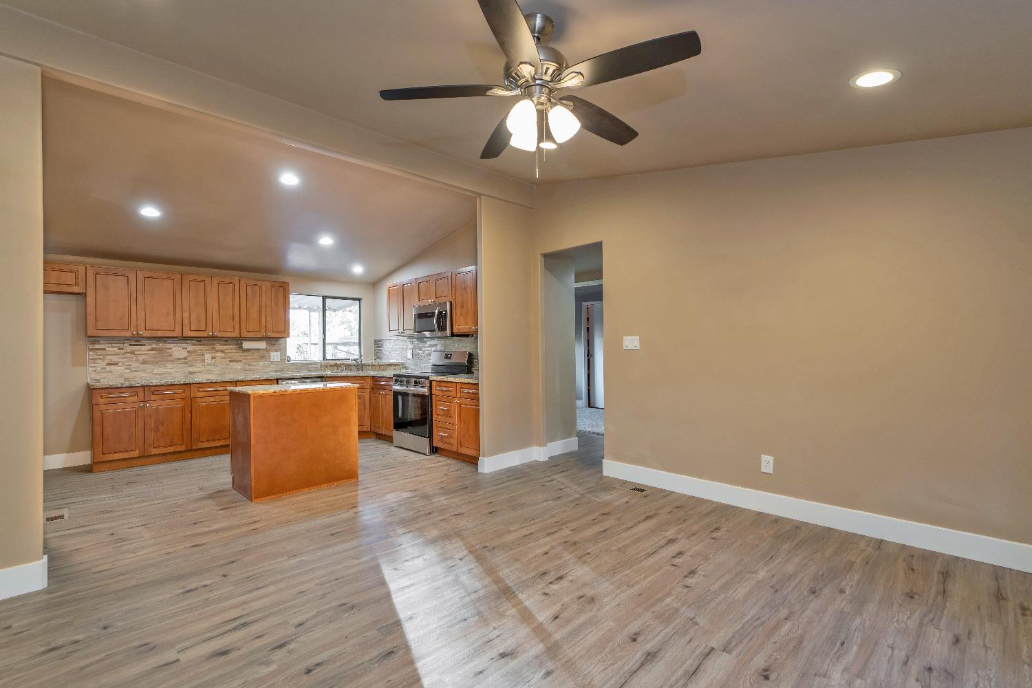 4420 Pleasant Valley Road, Unit 155 Diamond Springs, CA 95619 - Photo 19 of 42 a large kitchen with stainless steel appliances granite countertop a large counter top a sink and a refrigerator