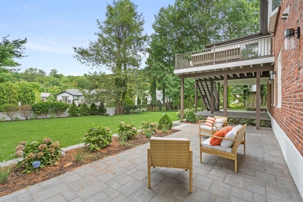 34 Donna Road Newton, MA 02459 - Photo 25 of 31 a backyard of a house with outdoor seating