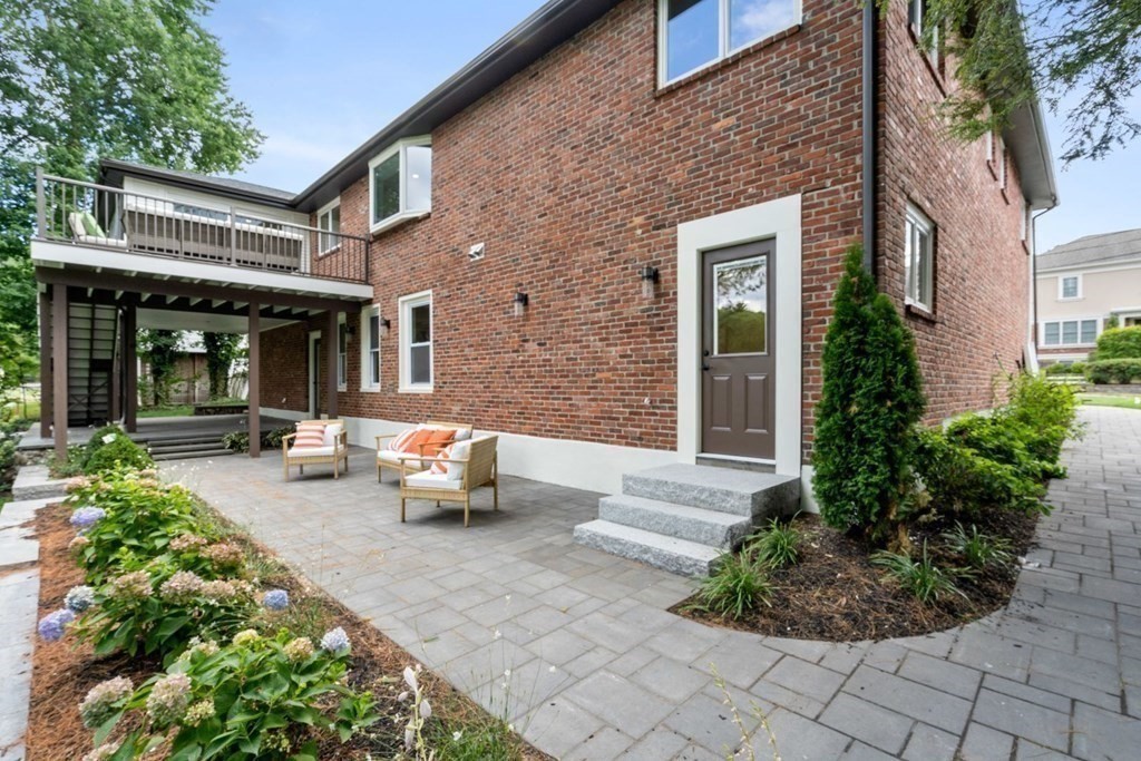 34 Donna Road Newton, MA 02459 - Photo 26 of 31 a view of a patio with couches table and chairs potted plants and large tree
