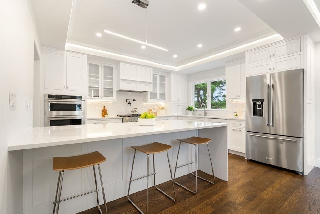 34 Donna Road Newton, MA 02459 - Photo 7 of 31 a kitchen with stainless steel appliances granite countertop a sink a stove a refrigerator and island with wooden floor