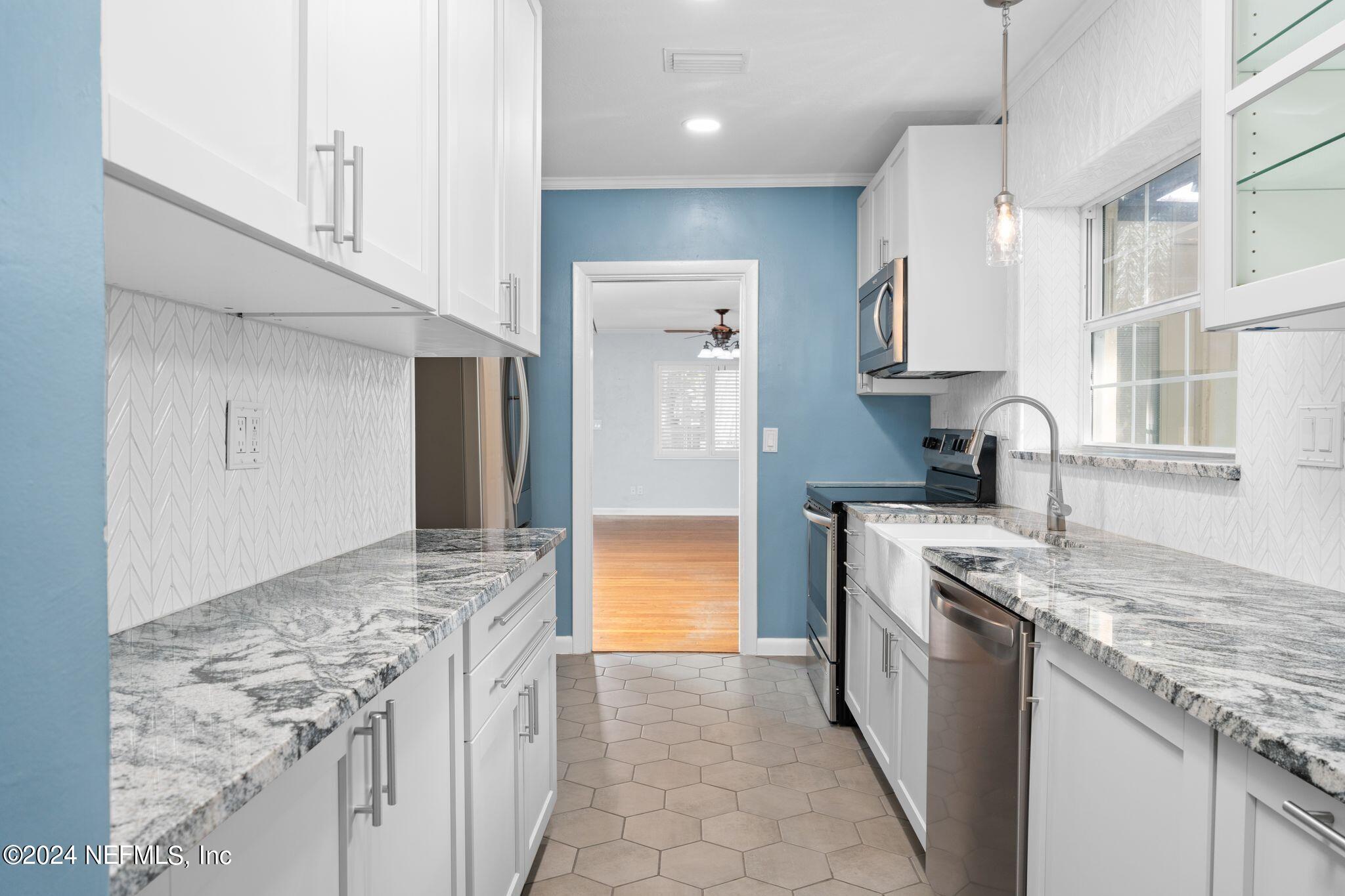 1704 Furman Road Jacksonville, FL 32217 - Photo 11 of 26 a kitchen with granite countertop a sink stove and refrigerator