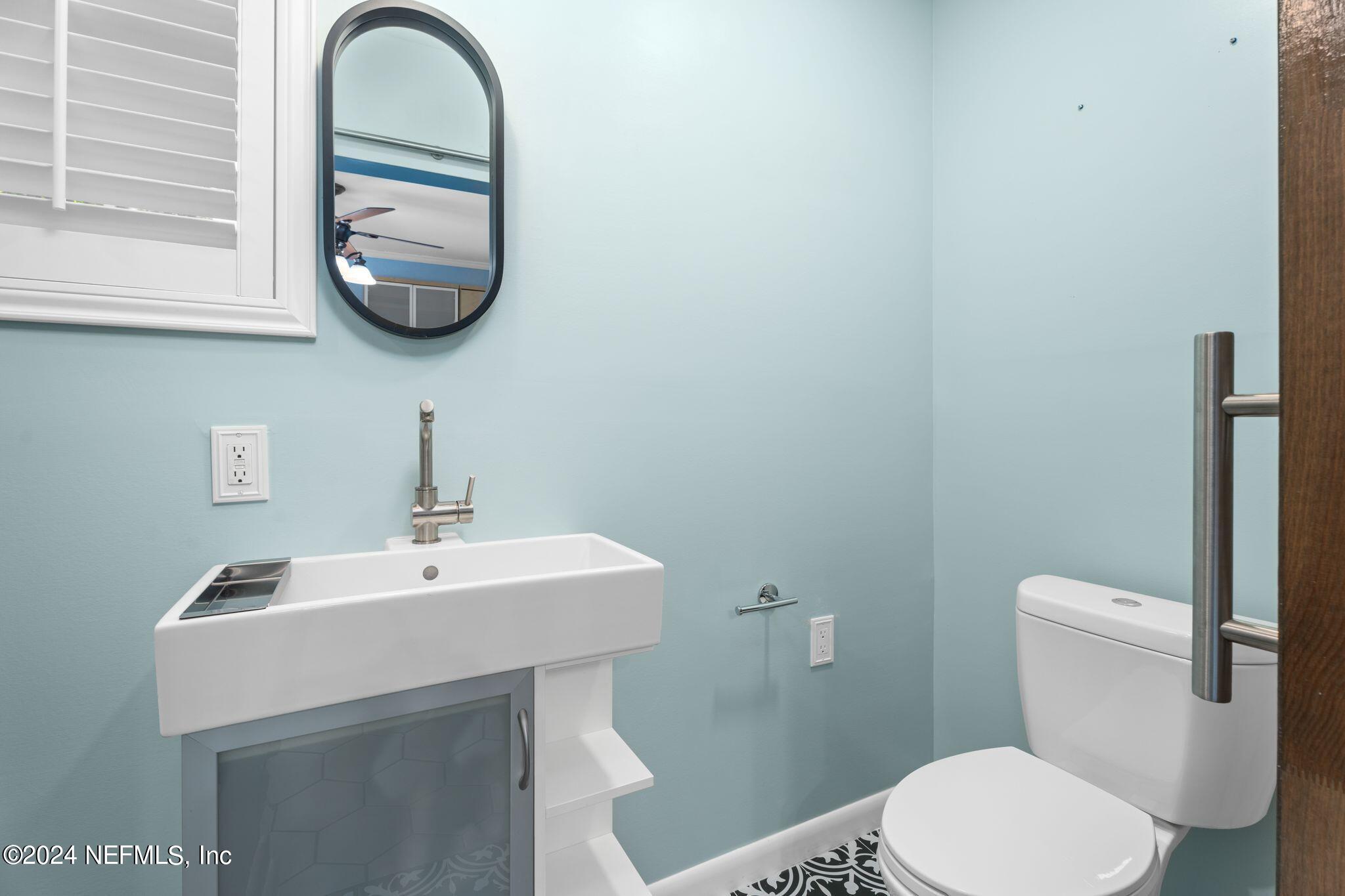 1704 Furman Road Jacksonville, FL 32217 - Photo 15 of 26 a bathroom with a toilet a sink and mirror