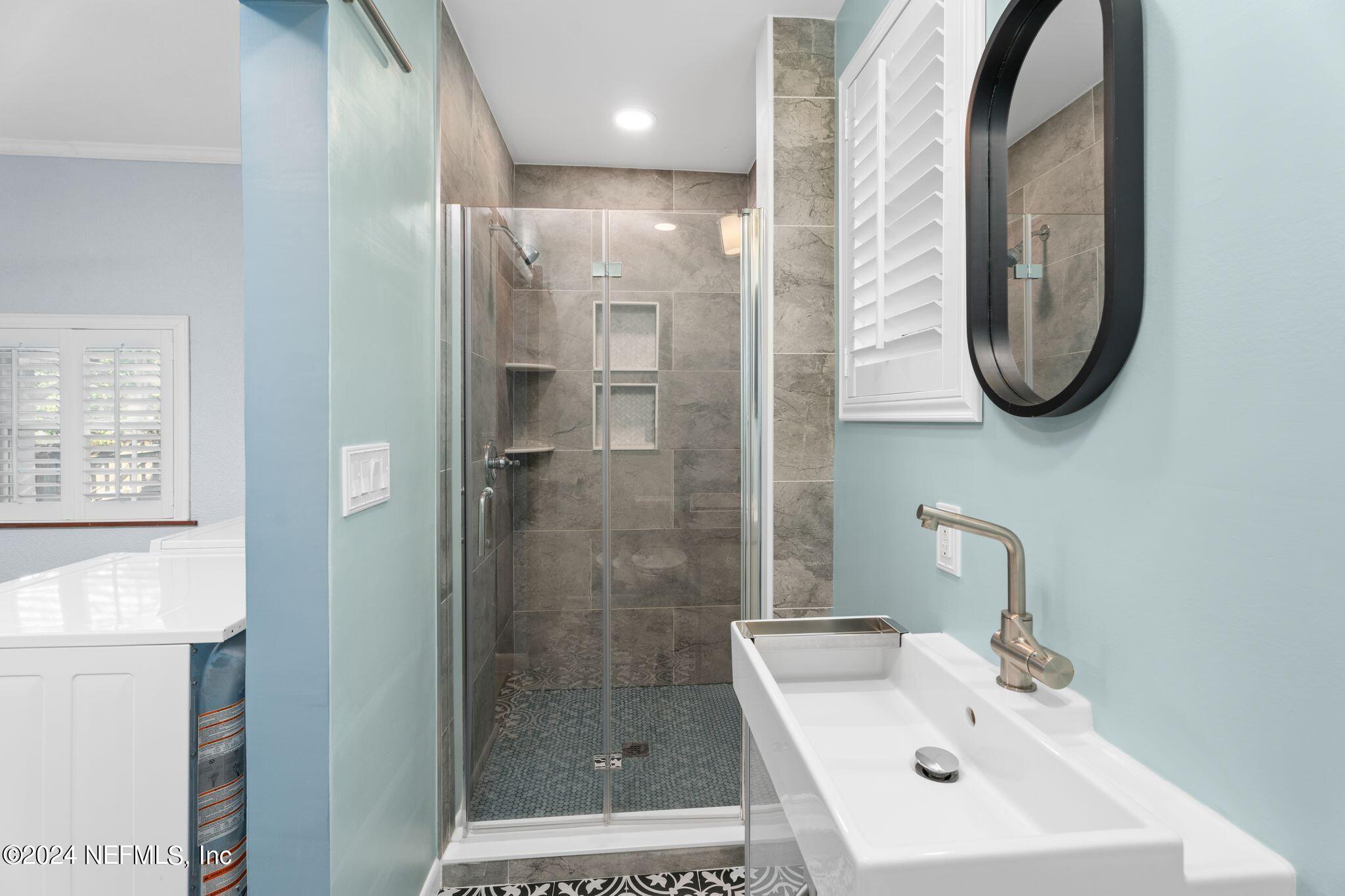 1704 Furman Road Jacksonville, FL 32217 - Photo 16 of 26 a bathroom with a sink a toilet and shower