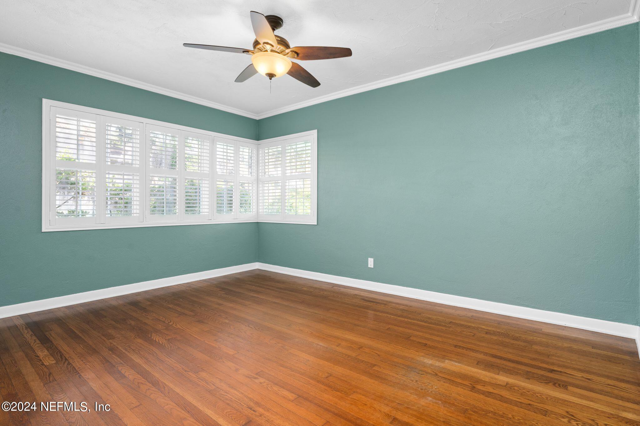 1704 Furman Road Jacksonville, FL 32217 - Photo 17 of 26 an empty room with wooden floor fan and windows