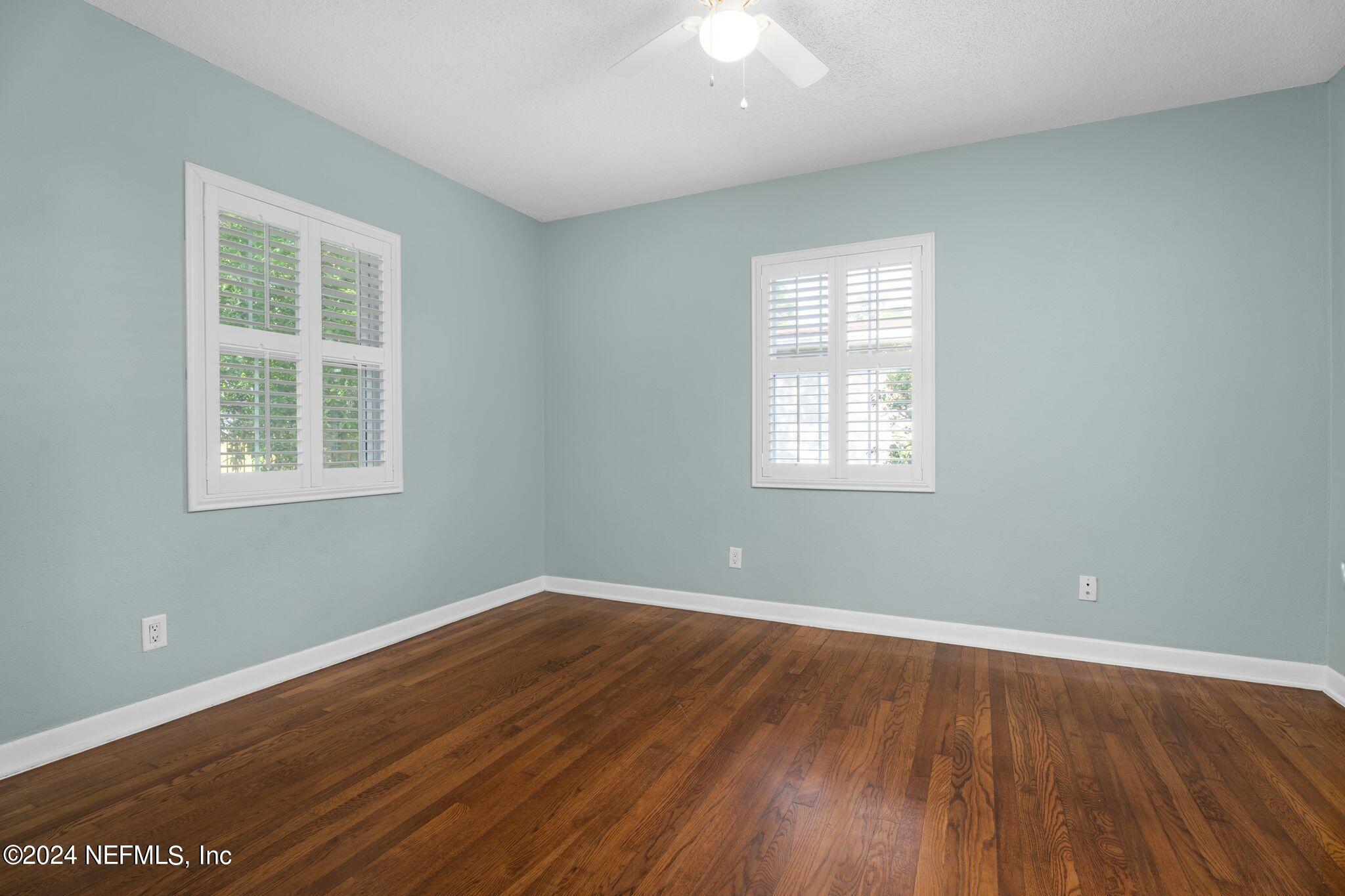 1704 Furman Road Jacksonville, FL 32217 - Photo 19 of 26 an empty room with wooden floor and windows