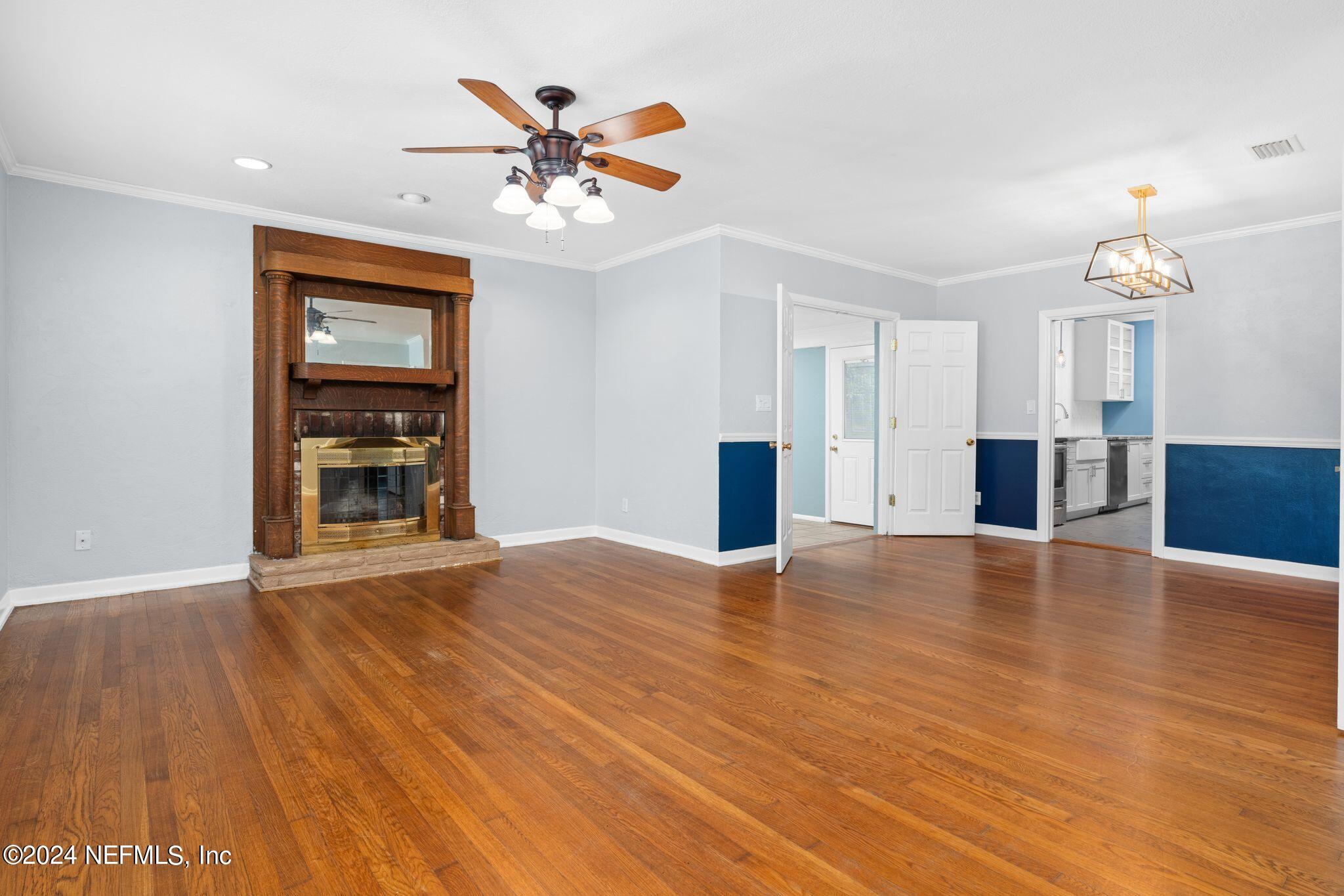 1704 Furman Road Jacksonville, FL 32217 - Photo 2 of 26 a view of an empty room with wooden floor and a window