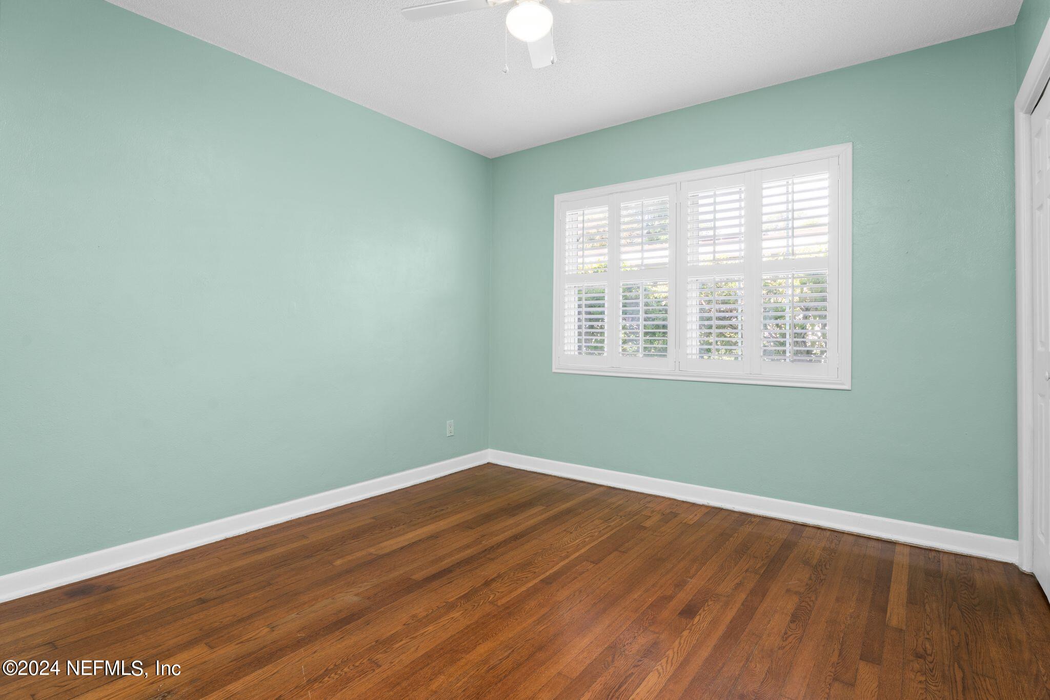 1704 Furman Road Jacksonville, FL 32217 - Photo 20 of 26 an empty room with wooden floor and windows