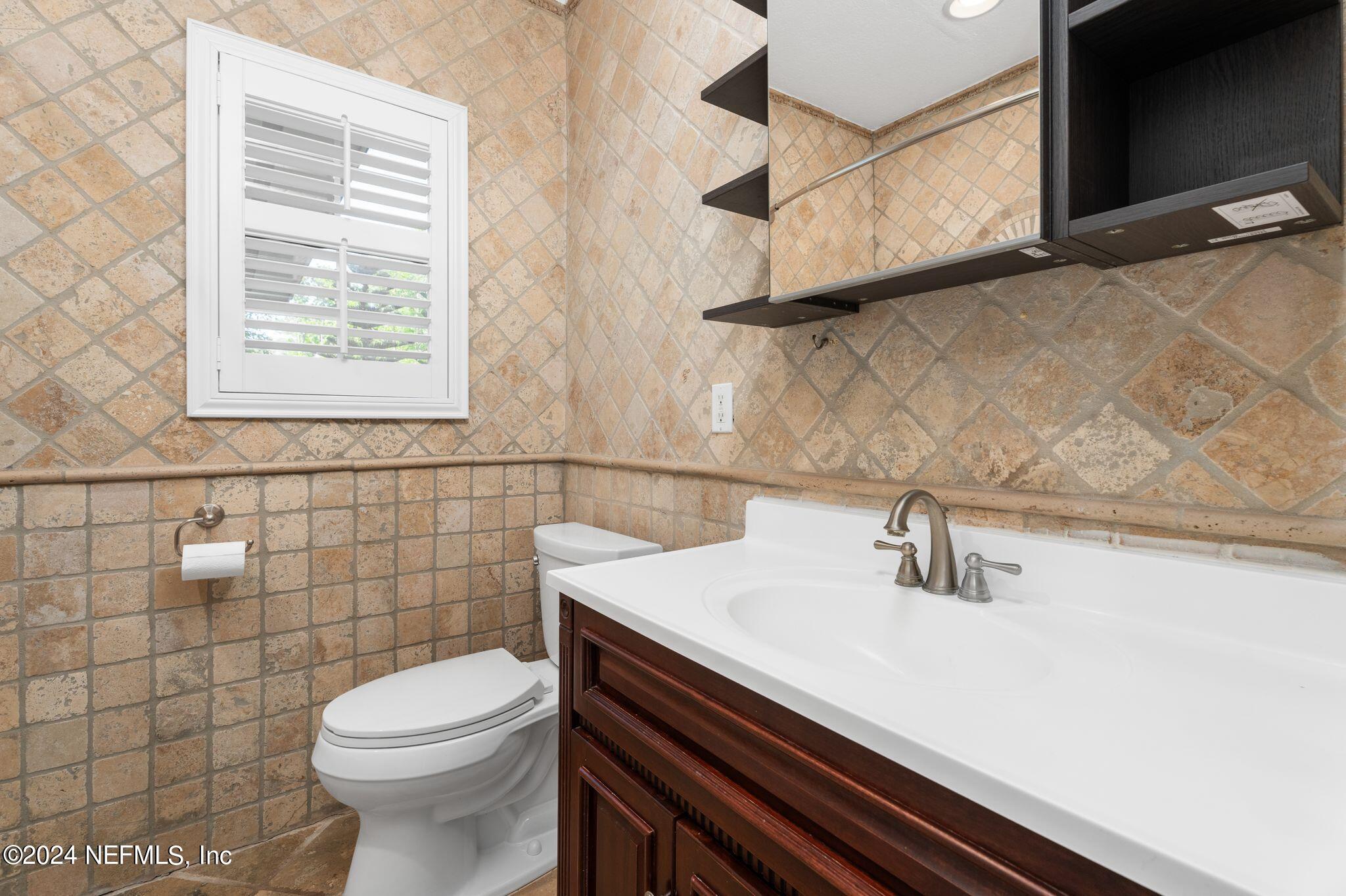 1704 Furman Road Jacksonville, FL 32217 - Photo 21 of 26 a bathroom with a sink a toilet and a mirror