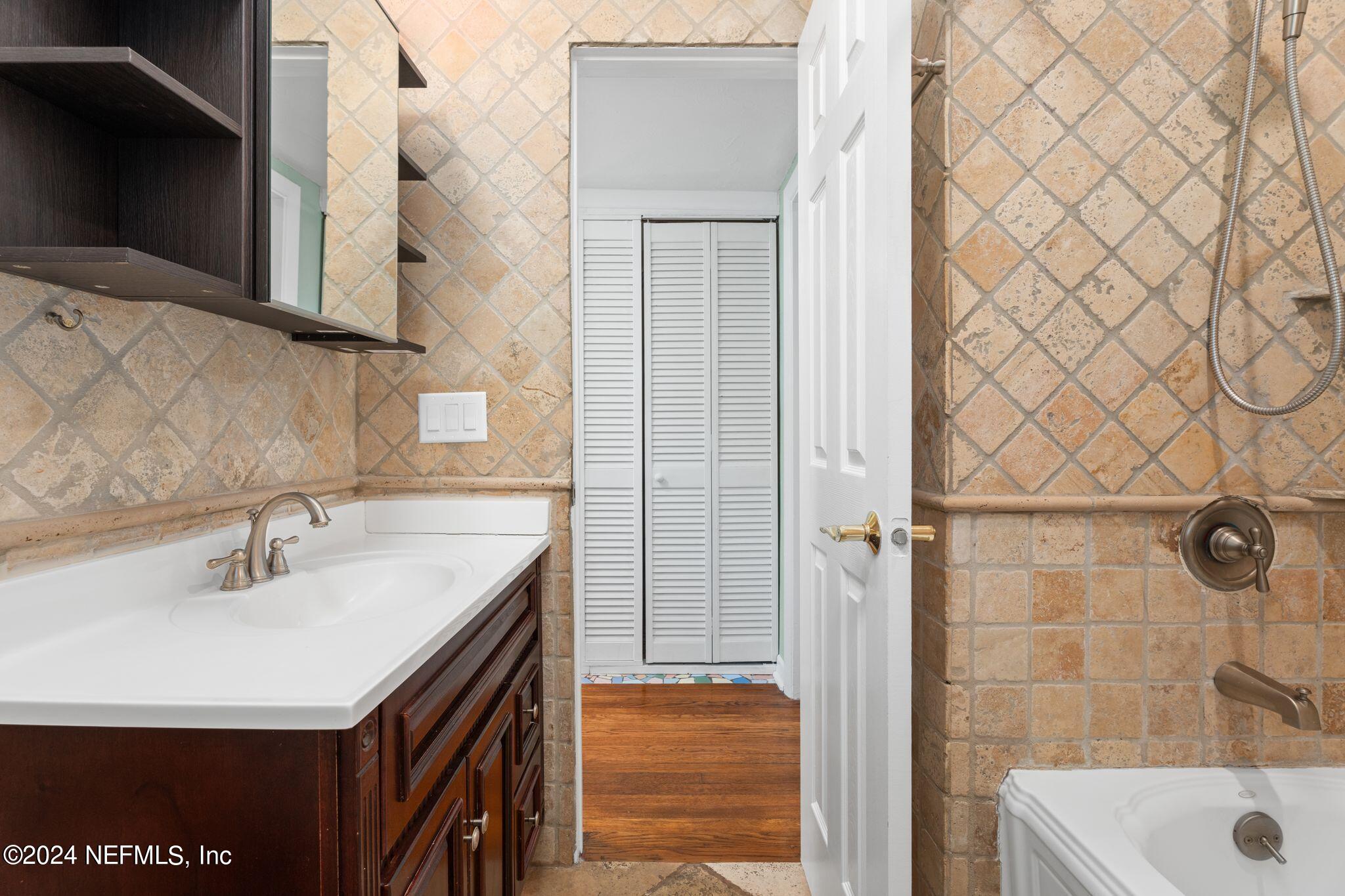 1704 Furman Road Jacksonville, FL 32217 - Photo 23 of 26 a bathroom with a sink and a mirror