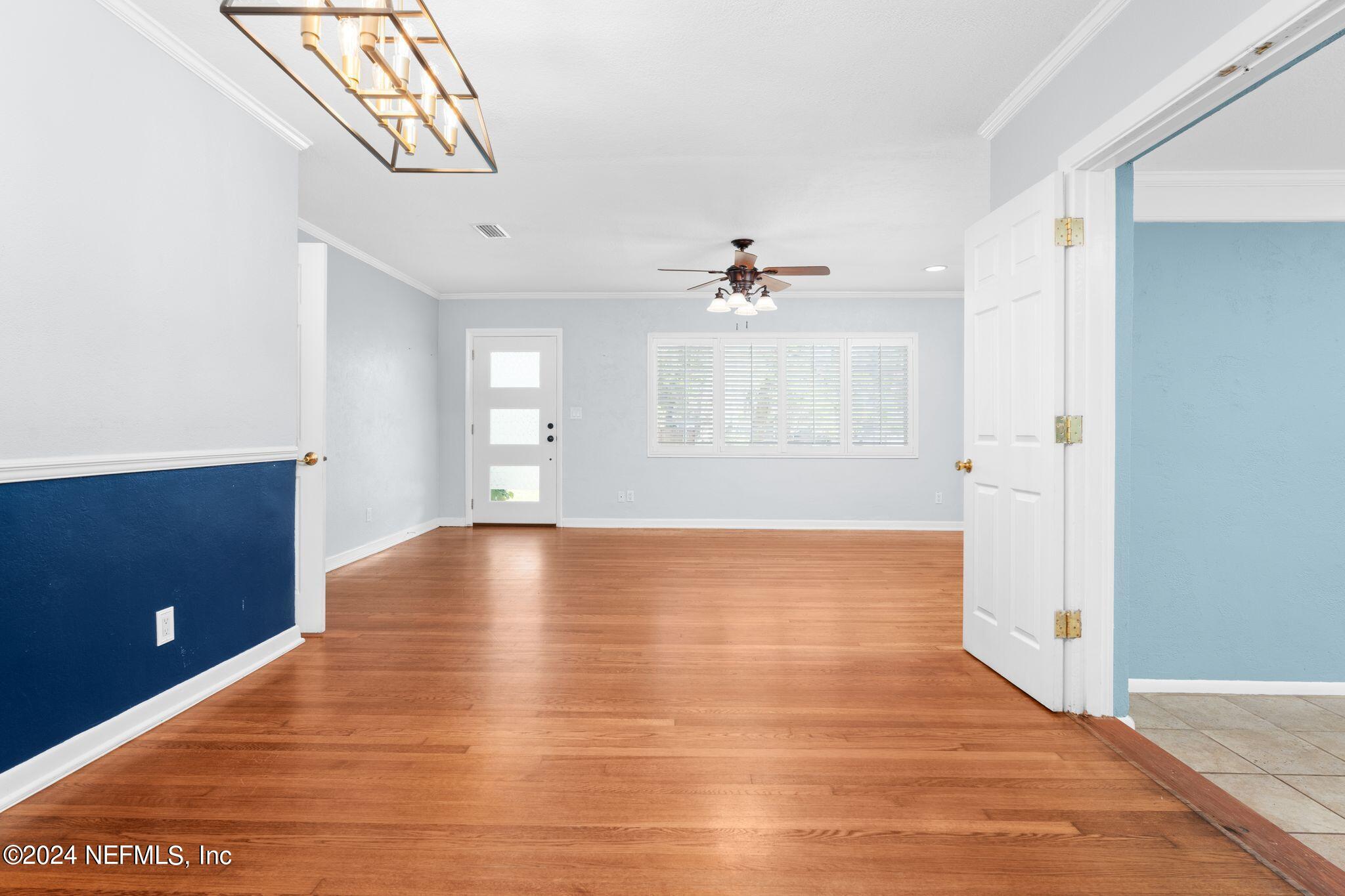 1704 Furman Road Jacksonville, FL 32217 - Photo 6 of 26 a view of an empty room with wooden floor and a window