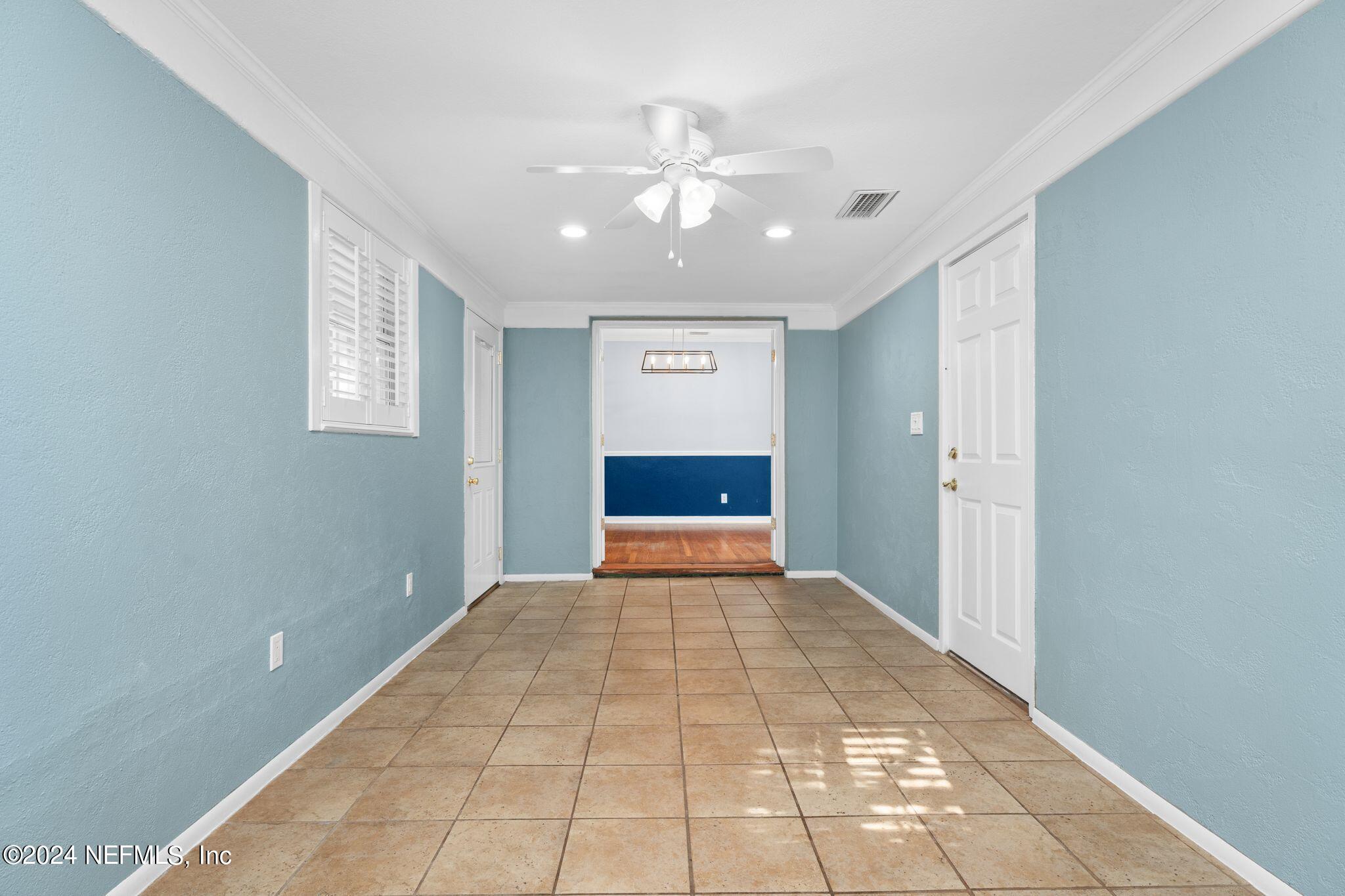 1704 Furman Road Jacksonville, FL 32217 - Photo 8 of 26 a view of a hallway with a chandelier fan and windows
