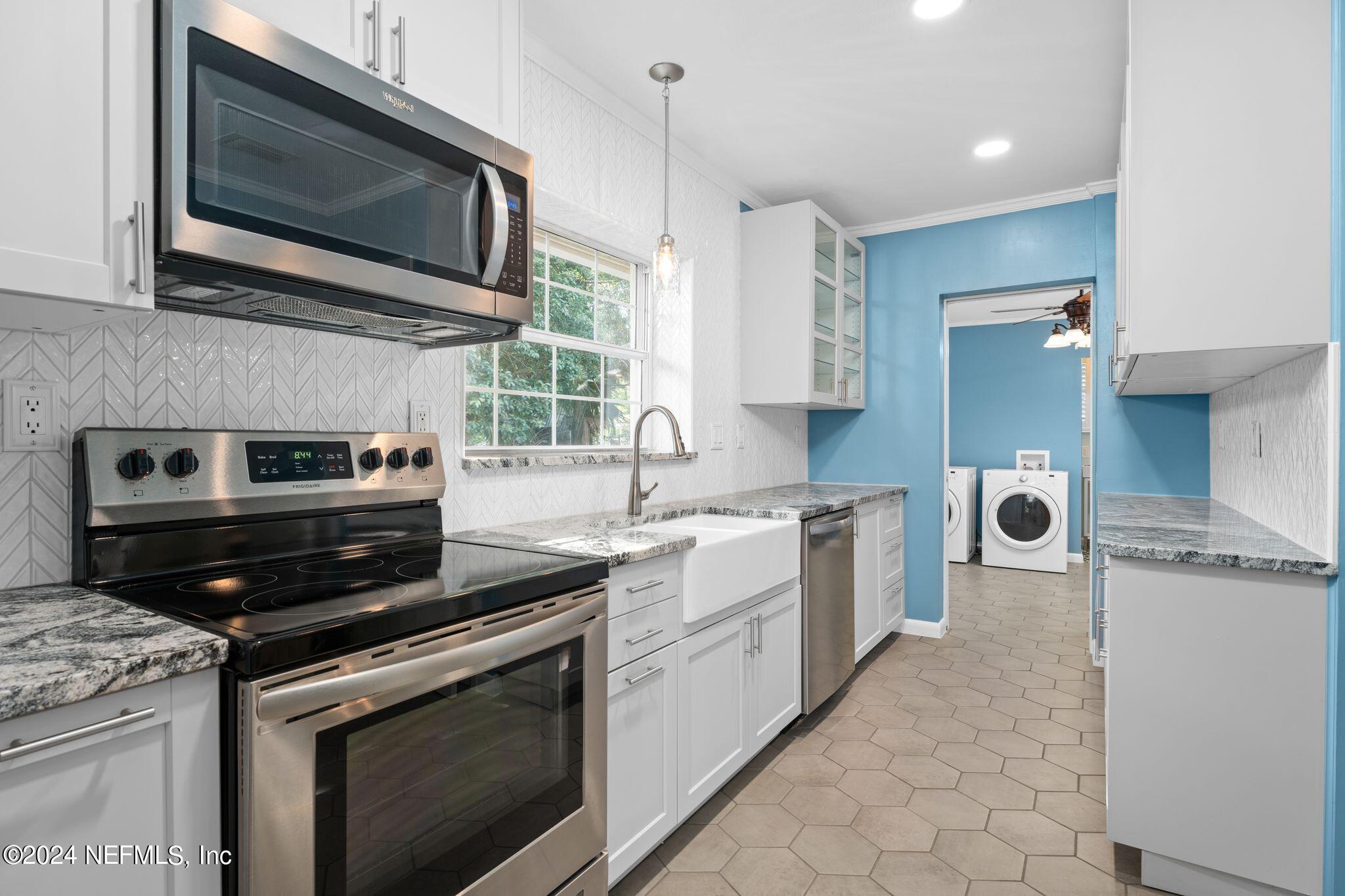 1704 Furman Road Jacksonville, FL 32217 - Photo 9 of 26 a kitchen with a stove and a microwave