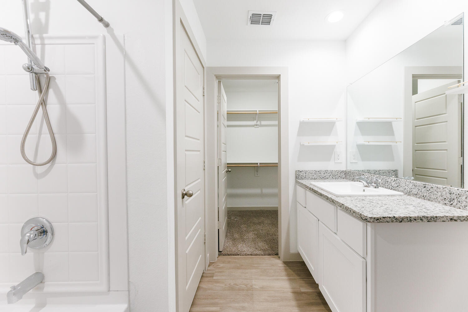 2305 150th Street Lubbock, TX 79423 - Photo 24 of 39 a bathroom with a granite countertop sink and a mirror