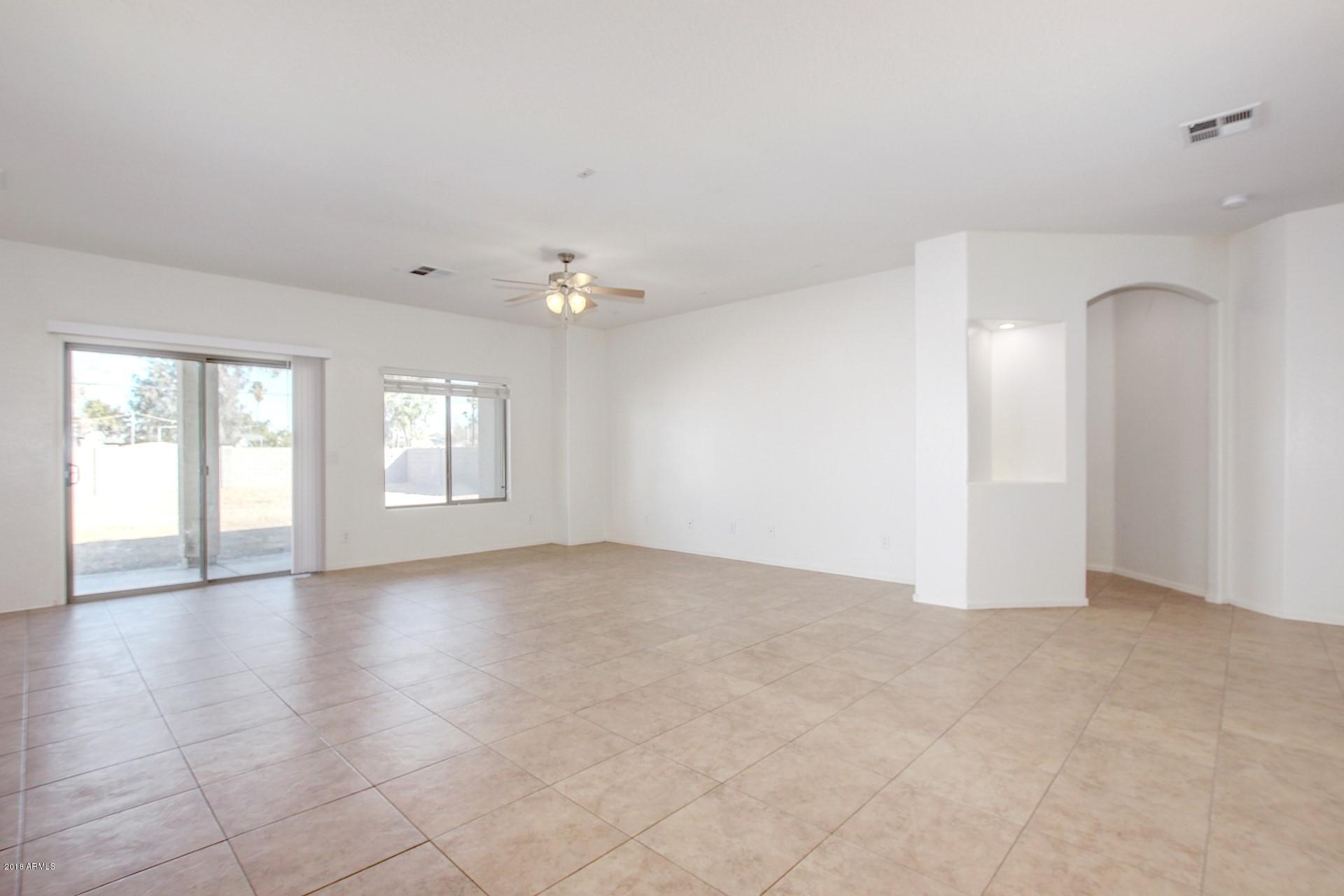 3036 East St John Road Phoenix, AZ 85032 - Photo 14 of 33 wooden floor in an empty room with a window