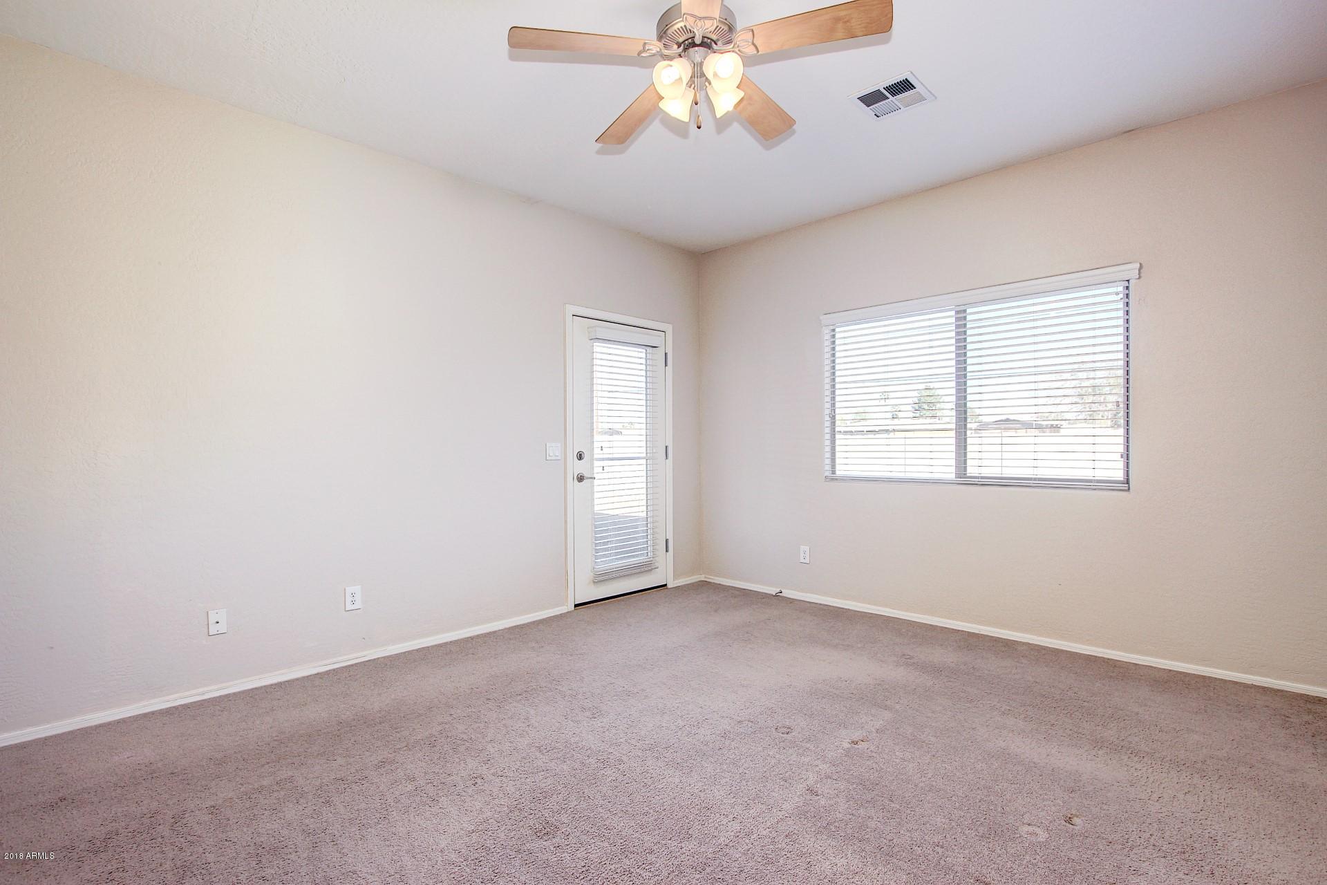 3036 East St John Road Phoenix, AZ 85032 - Photo 16 of 33 an empty room with a window and a fan