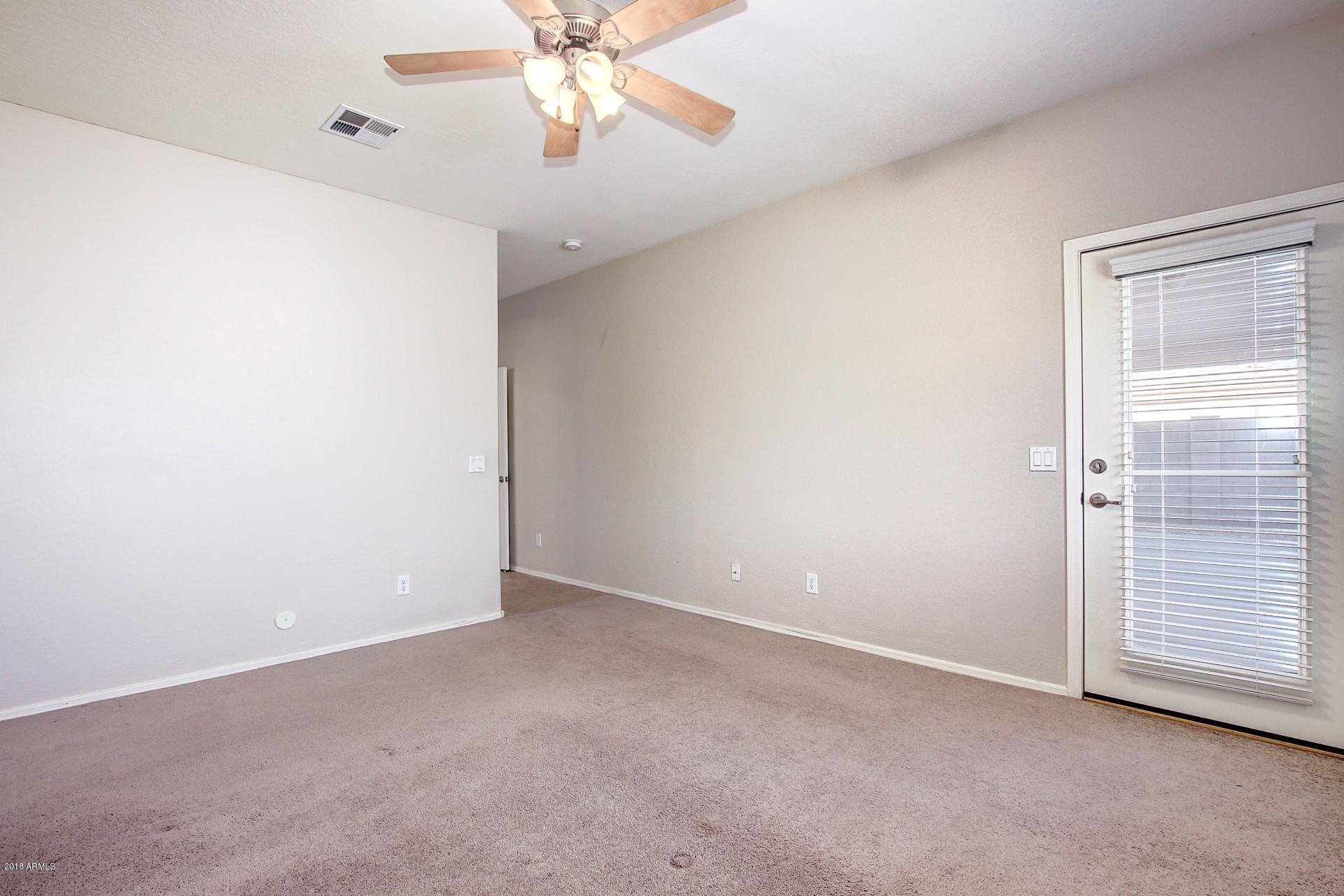 3036 East St John Road Phoenix, AZ 85032 - Photo 17 of 33 an empty room with windows and fan