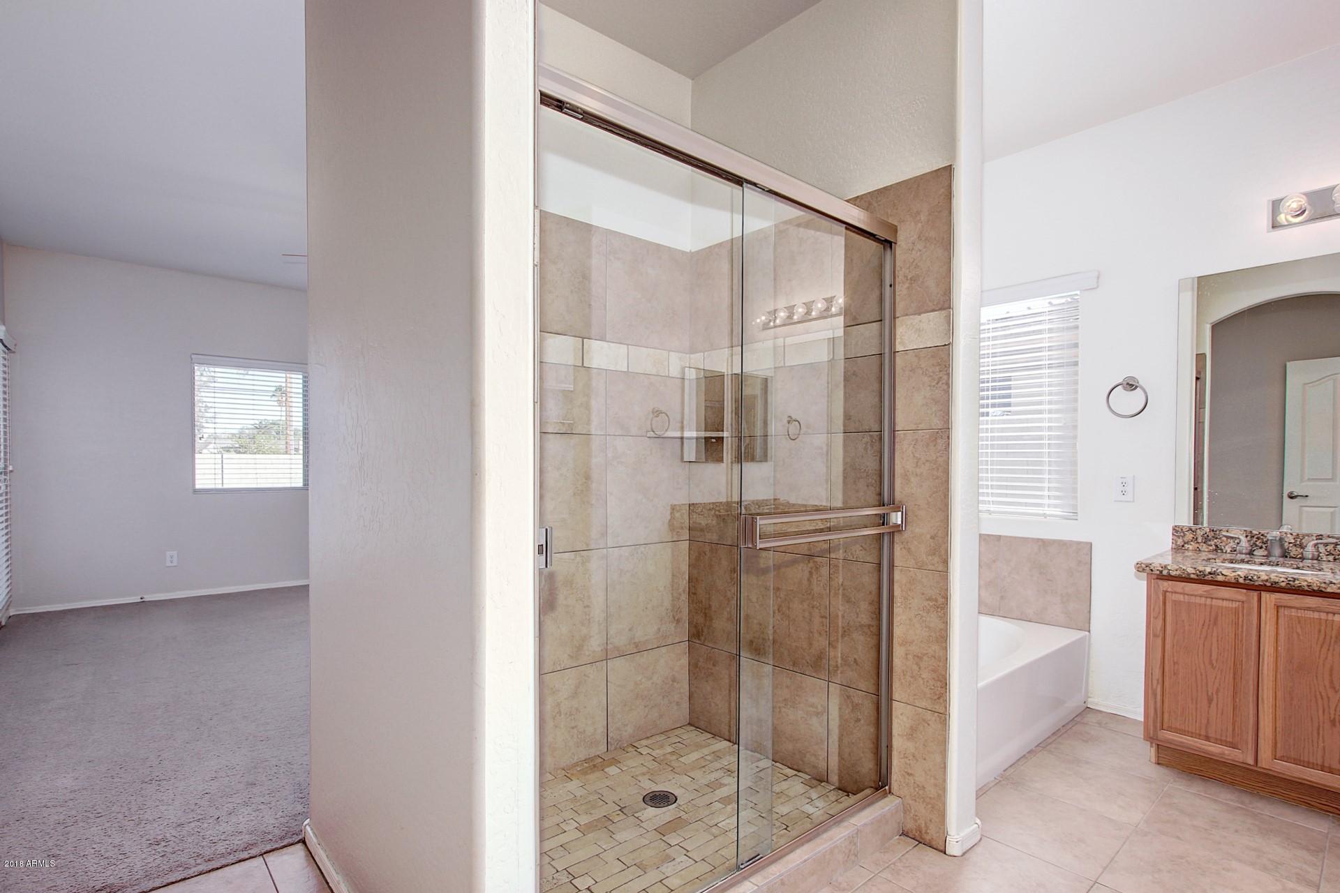 3036 East St John Road Phoenix, AZ 85032 - Photo 18 of 33 a bathroom with a shower and a sink