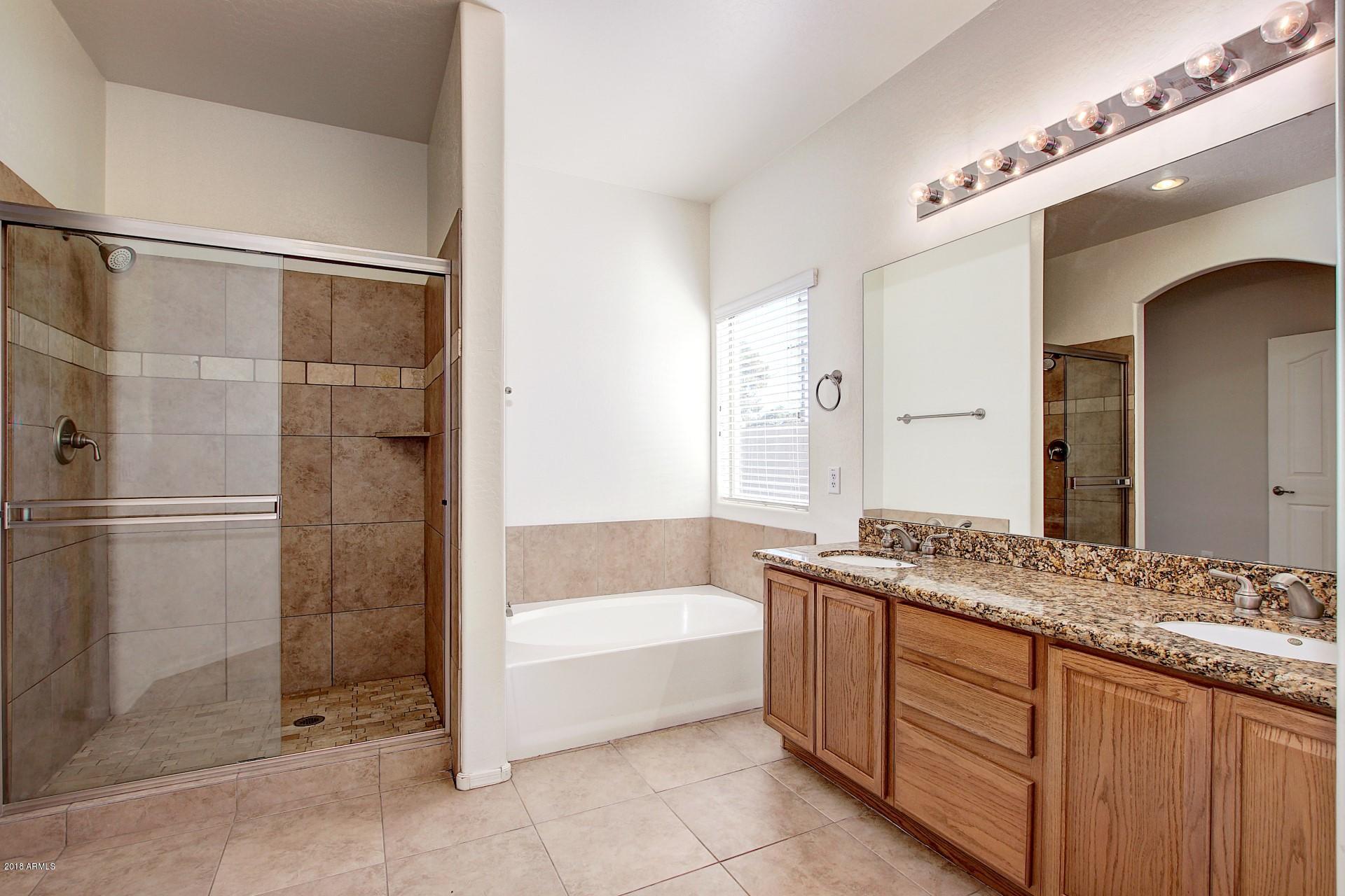 3036 East St John Road Phoenix, AZ 85032 - Photo 20 of 33 a bathroom with a granite countertop bathtub sink vanity and mirror