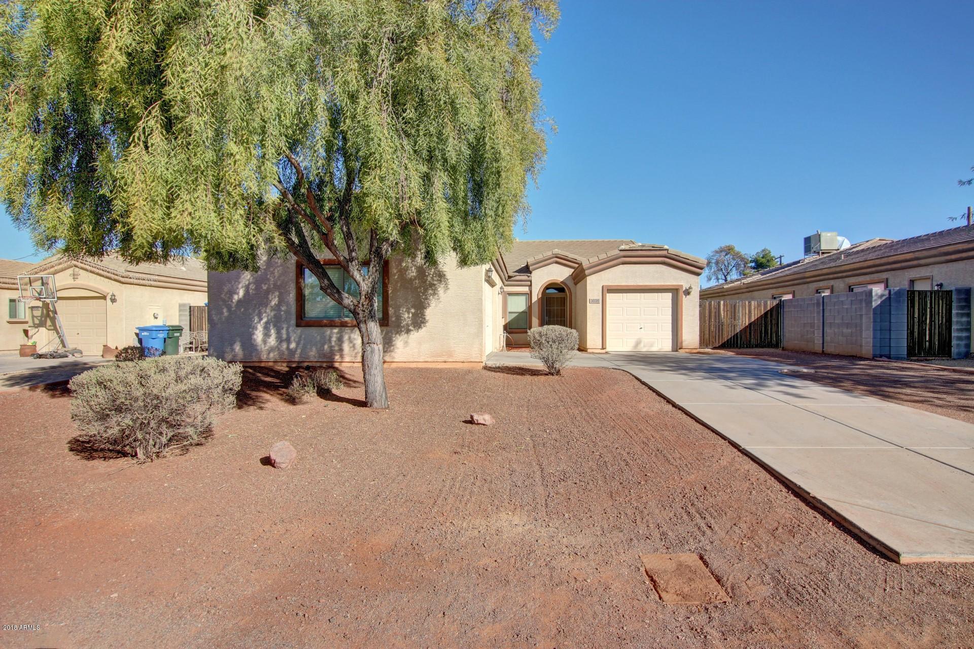 3036 East St John Road Phoenix, AZ 85032 - Photo 2 of 33 a tall house with a large tree in front of it