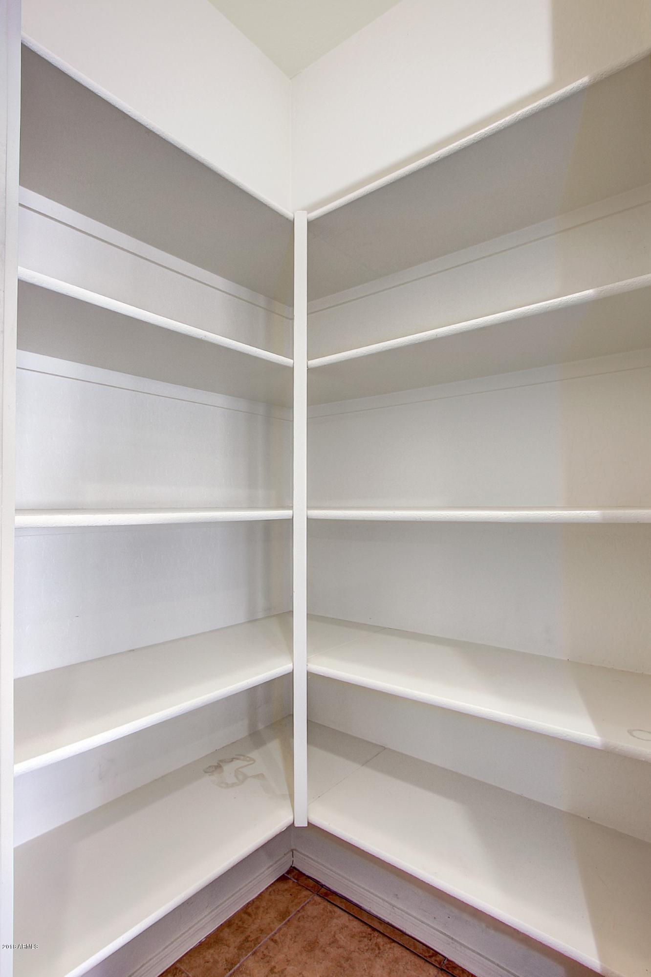 3036 East St John Road Phoenix, AZ 85032 - Photo 22 of 33 a view of walk in closet with empty racks