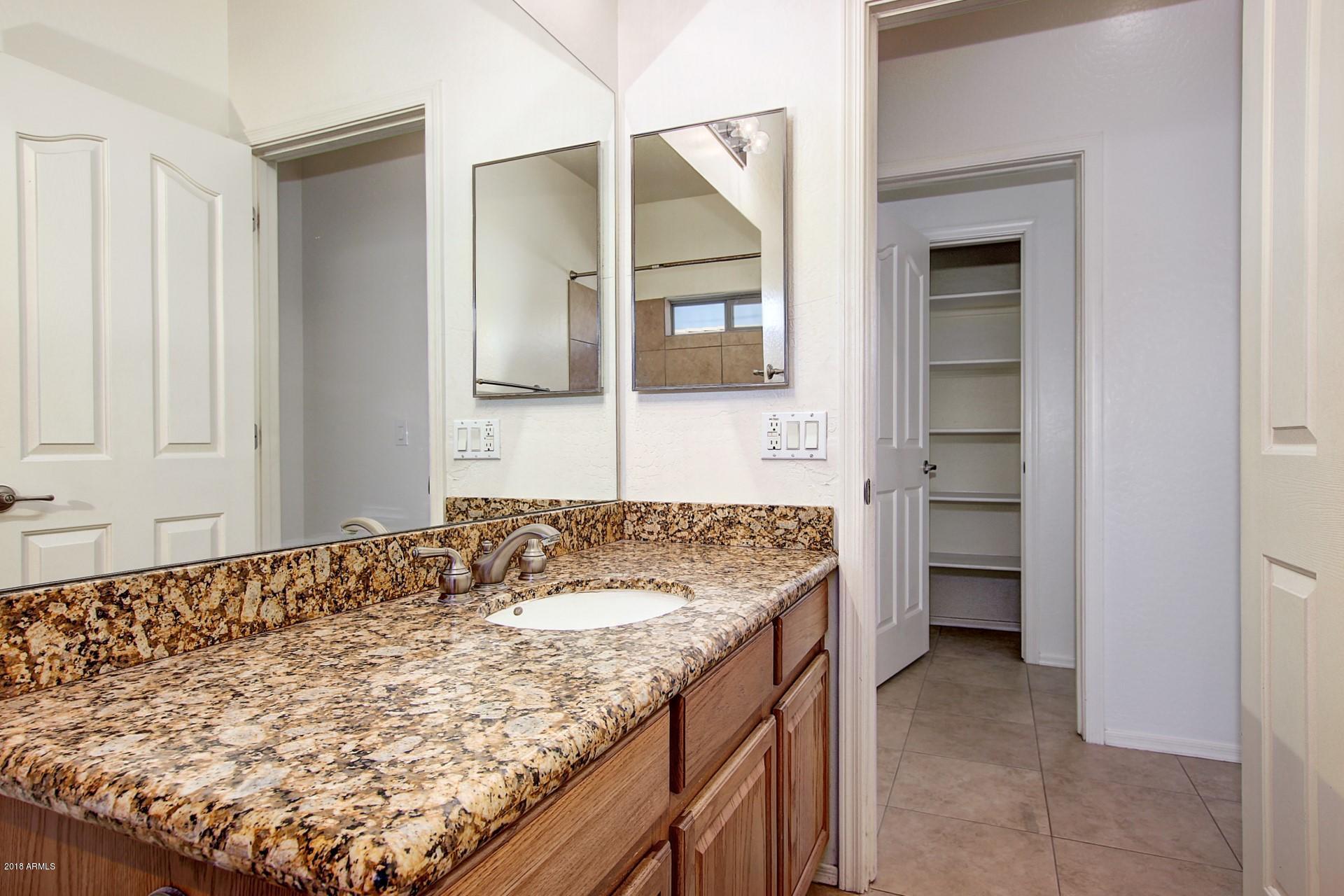 3036 East St John Road Phoenix, AZ 85032 - Photo 26 of 33 a en suite bathroom with a granite countertop sink and a mirror