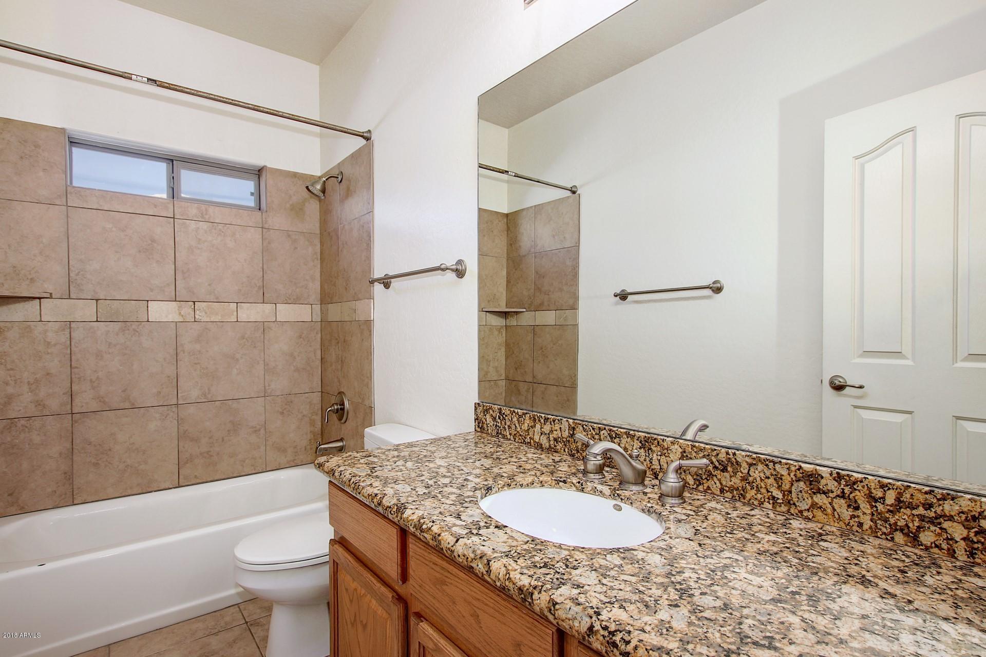3036 East St John Road Phoenix, AZ 85032 - Photo 27 of 33 a bathroom with a sink a toilet and shower
