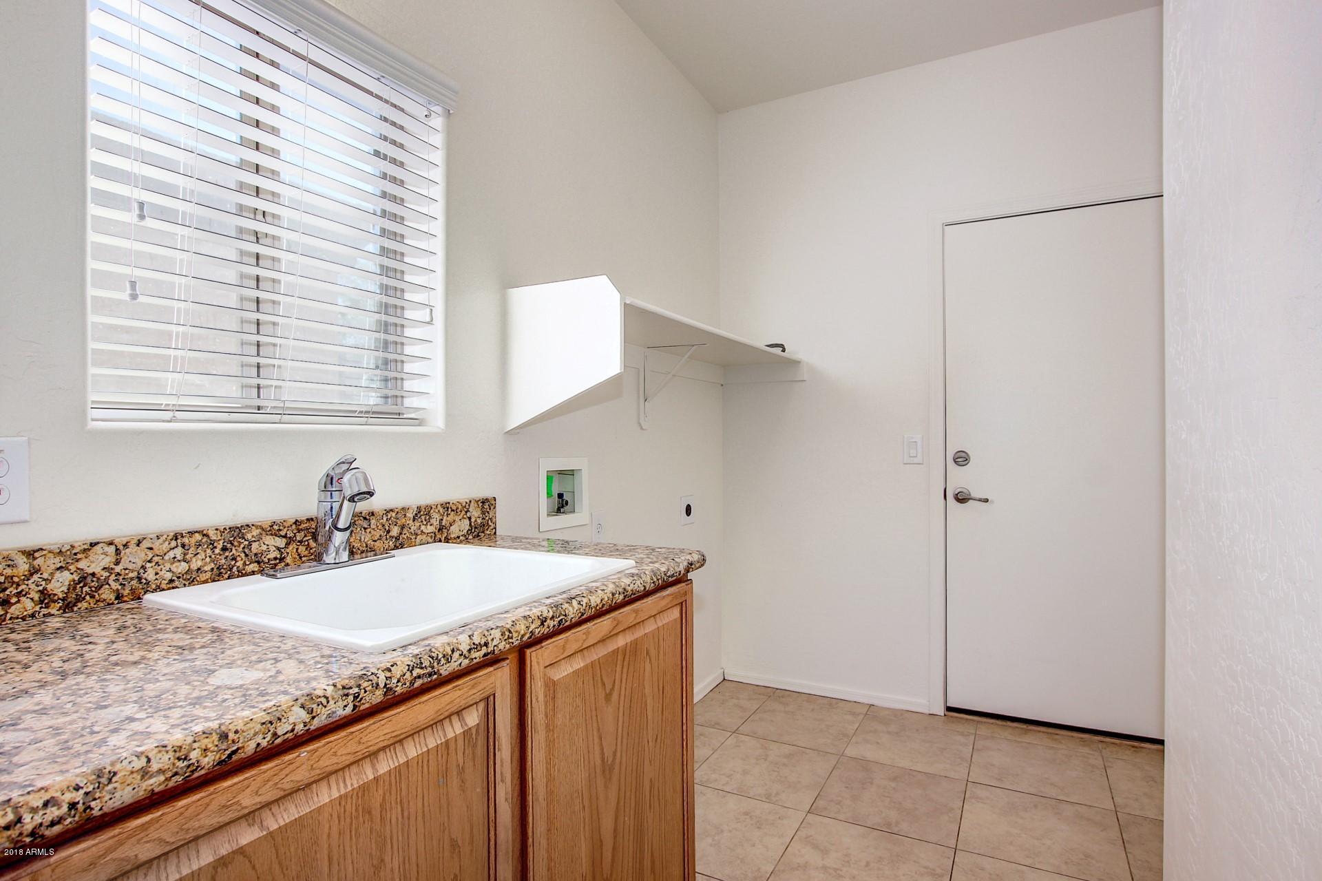3036 East St John Road Phoenix, AZ 85032 - Photo 28 of 33 a bathroom with a granite countertop sink and a mirror