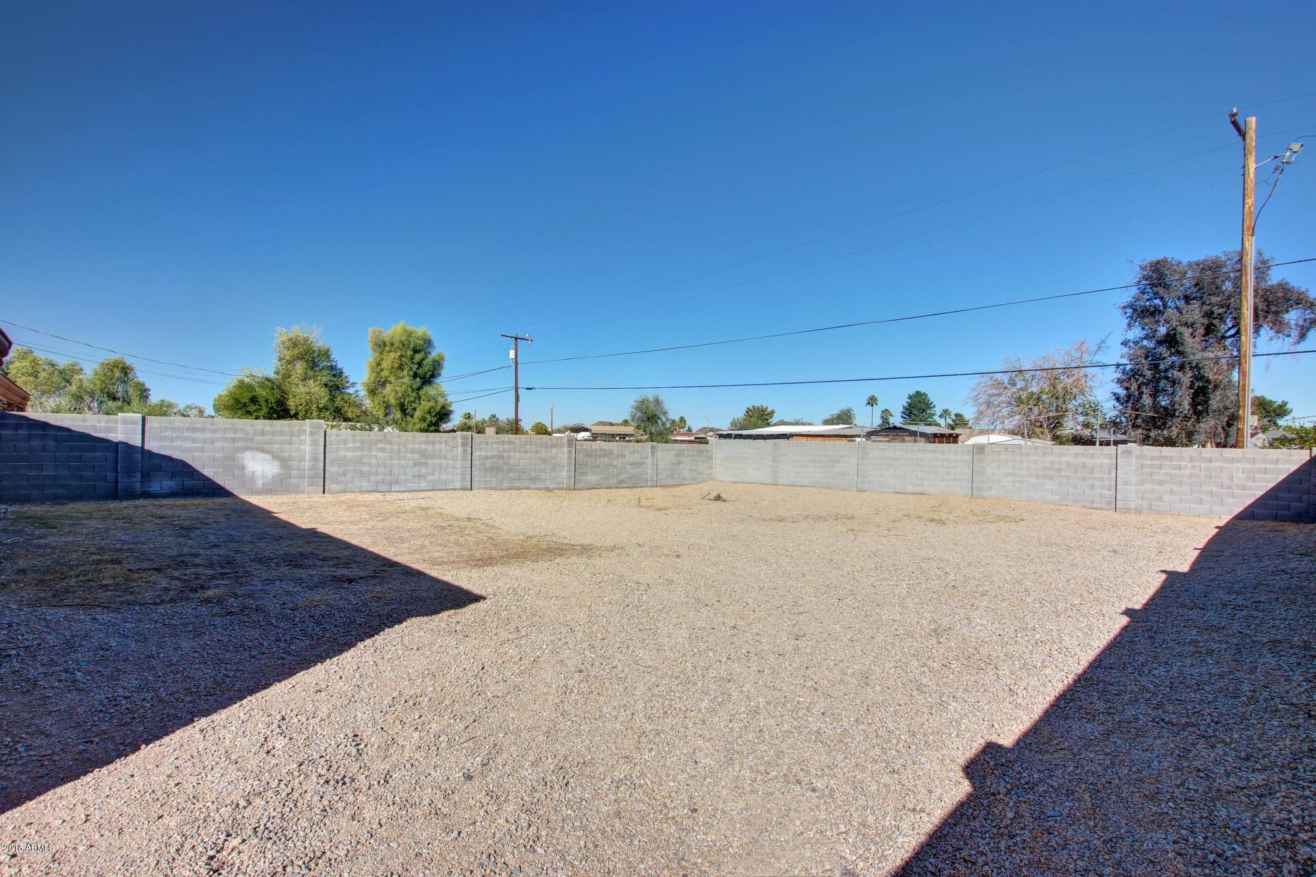 3036 East St John Road Phoenix, AZ 85032 - Photo 29 of 33 a view of a dry yard with a house