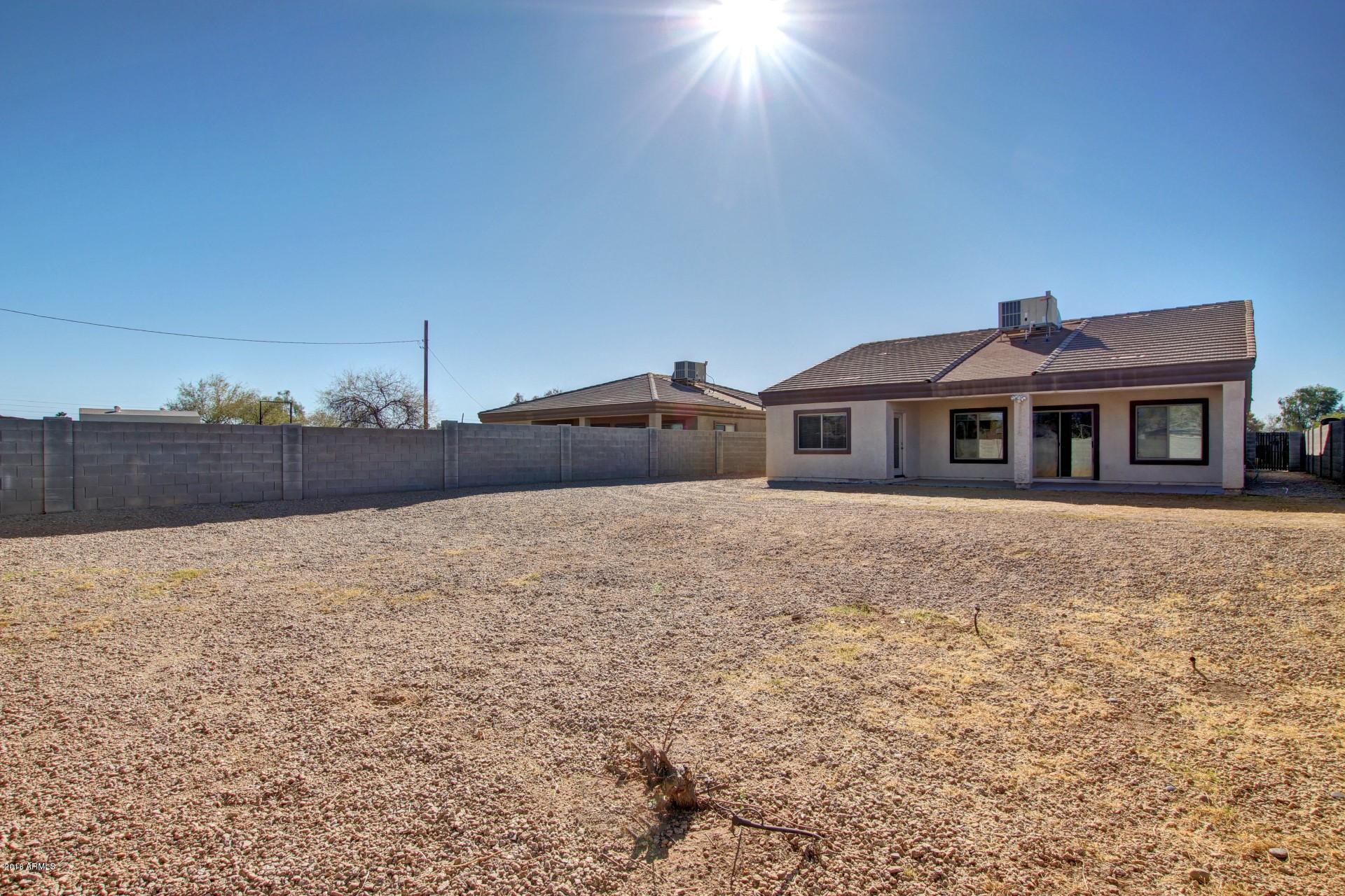 3036 East St John Road Phoenix, AZ 85032 - Photo 31 of 33 a front view of a house with a yard