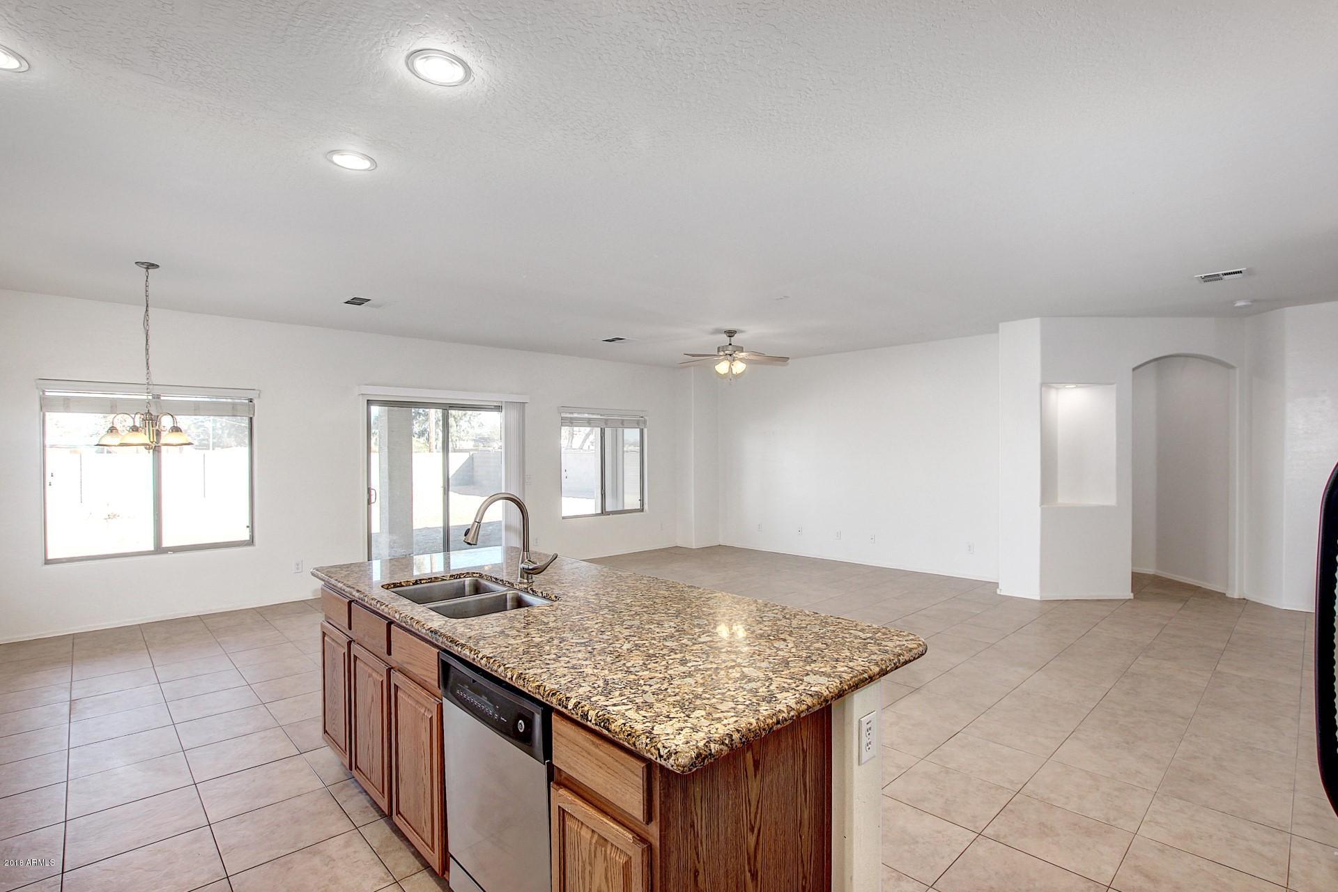3036 East St John Road Phoenix, AZ 85032 - Photo 6 of 33 a kitchen with granite countertop a sink cabinets and window