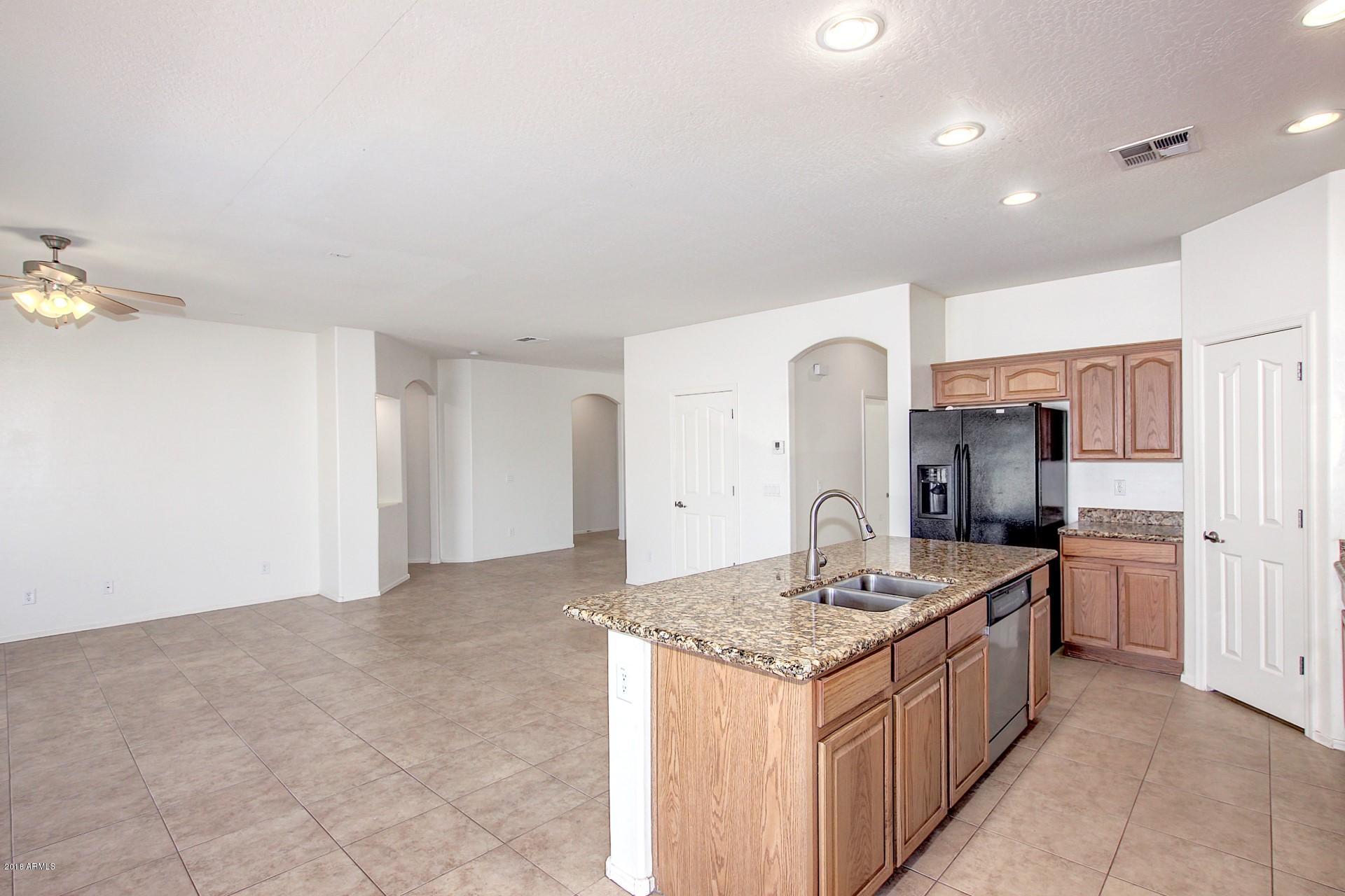 3036 East St John Road Phoenix, AZ 85032 - Photo 8 of 33 a kitchen with stainless steel appliances granite countertop a sink and a stove